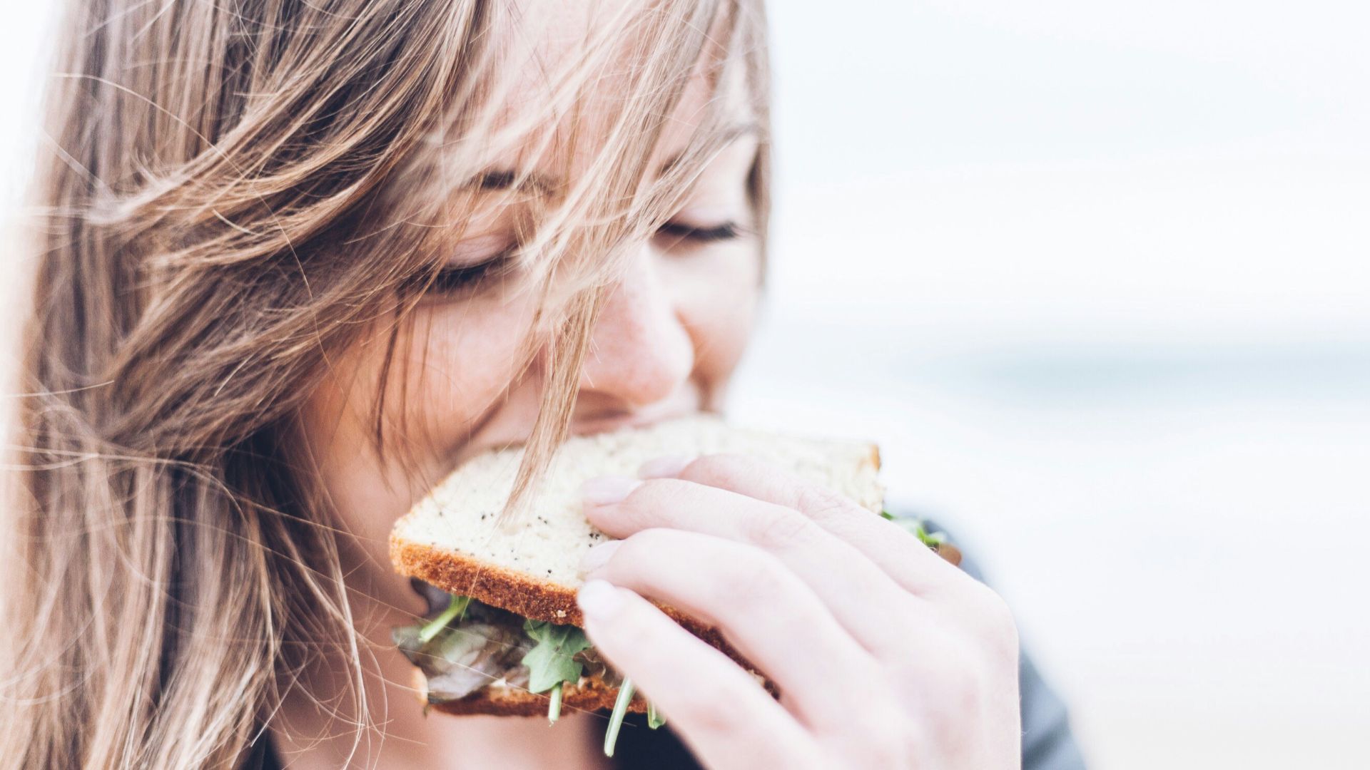 woman eating sandwich