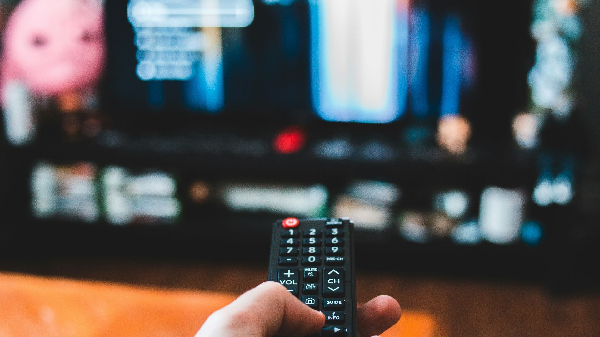 person holding black remote control