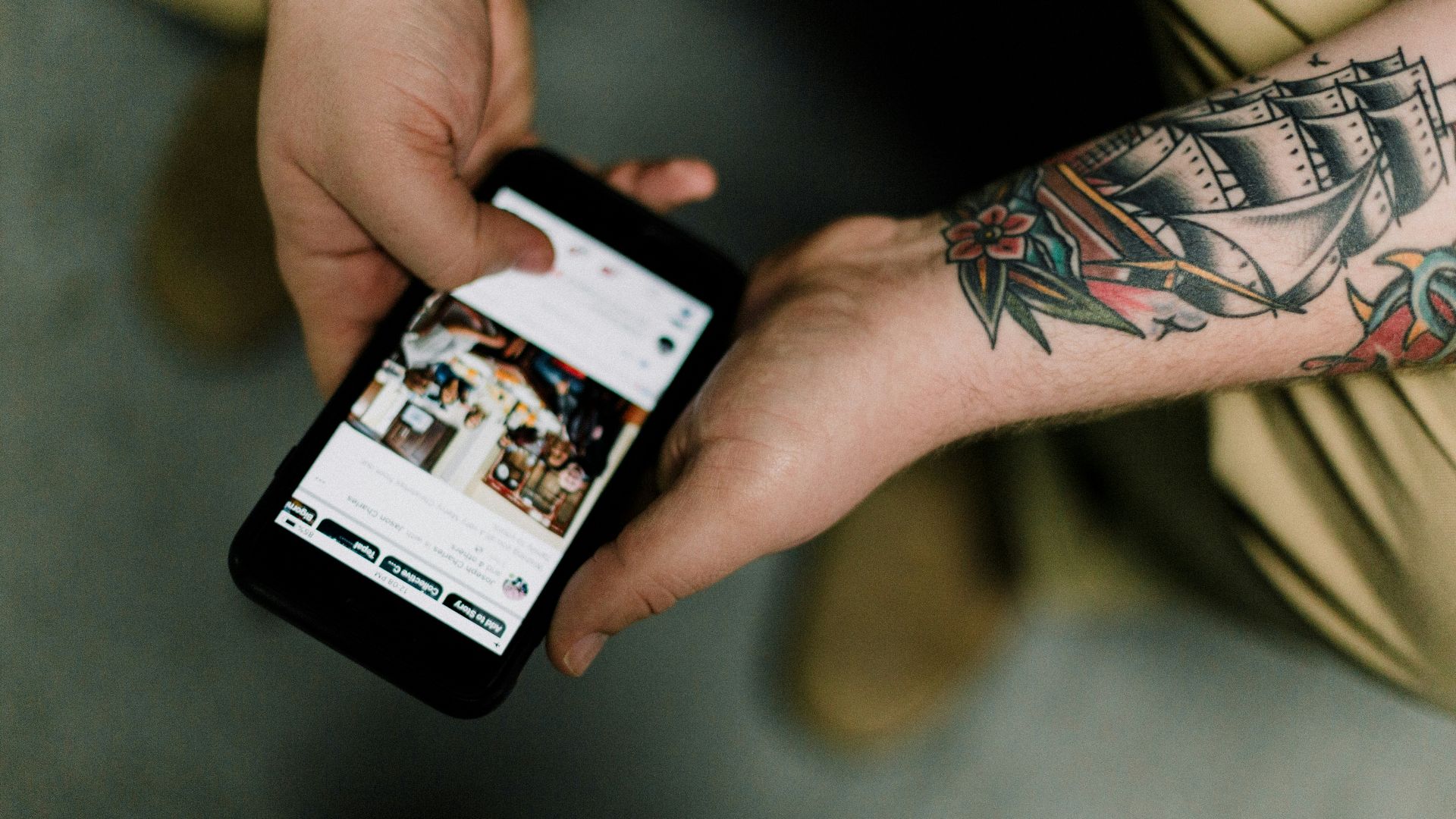 person holding black iphone 4