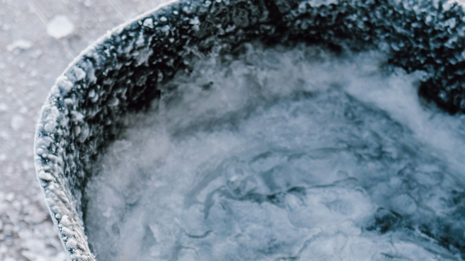 a bucket filled with ice sitting on top of a wooden floor