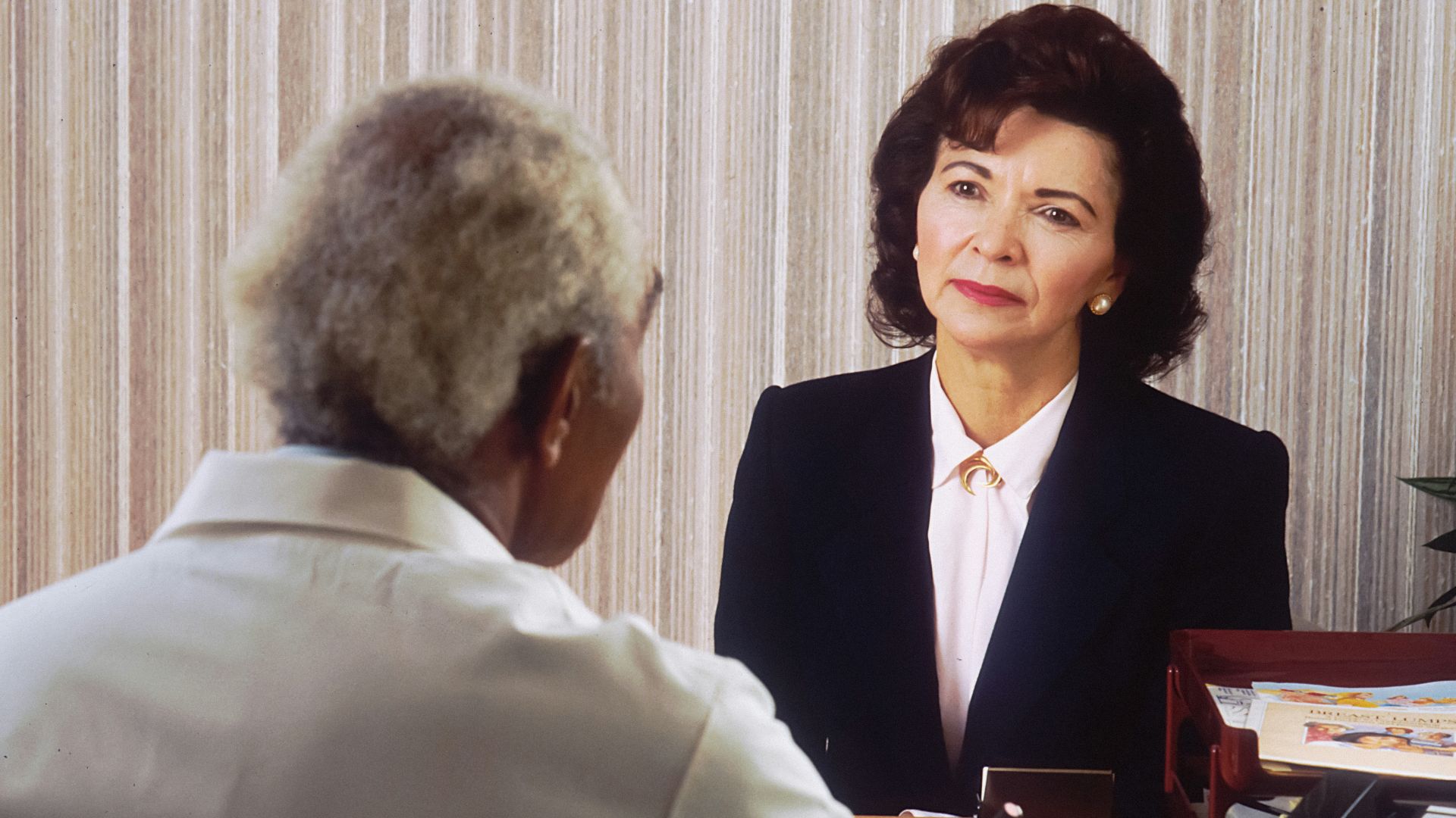 man in black suit jacket standing beside woman in white dress shirt
