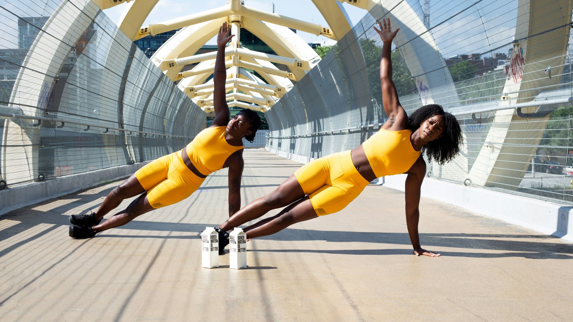 woman in yellow sports bra and yellow shorts jumping on white metal frame
