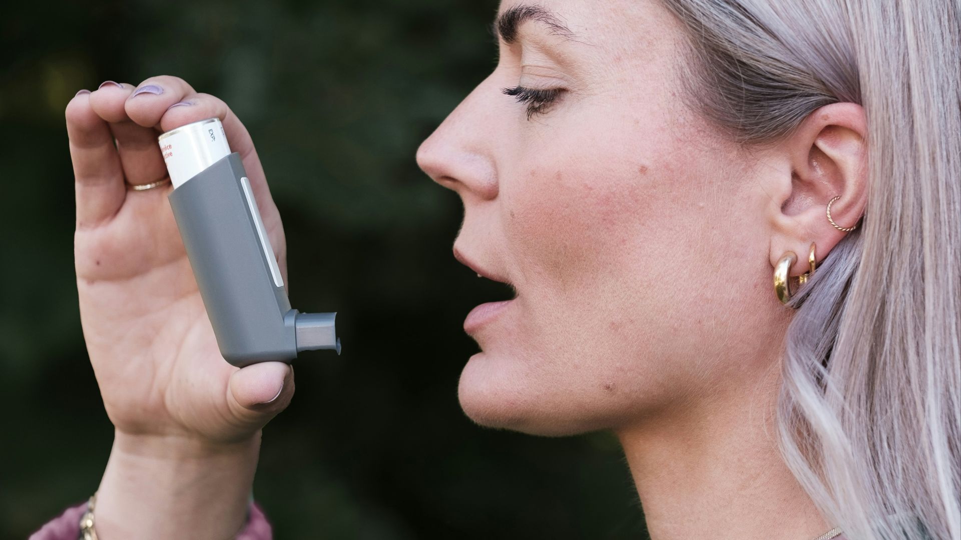 A woman holding a cell phone up to her face
