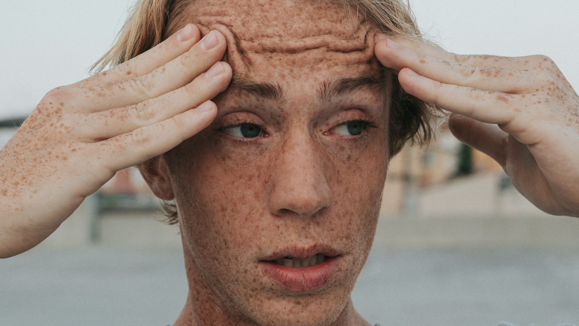 man in gray crew neck shirt with brown hair