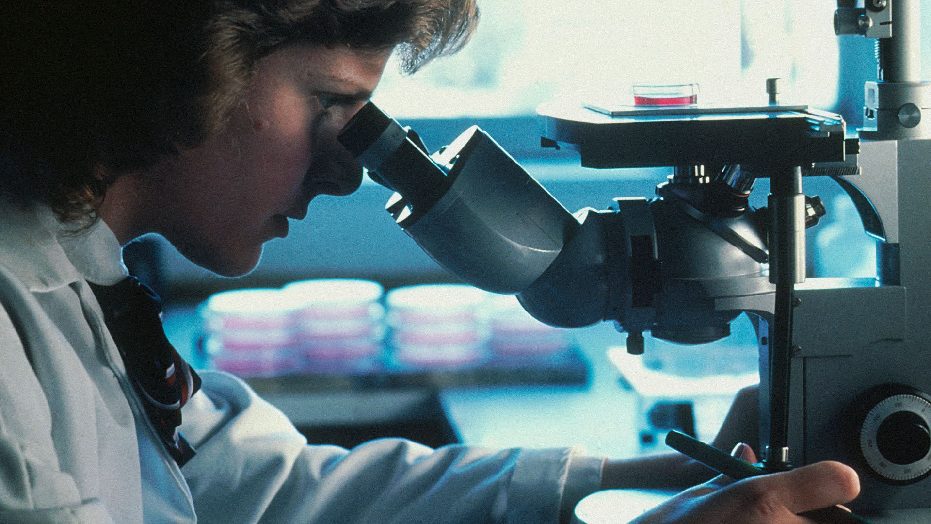 man in white long sleeve shirt holding black dslr camera