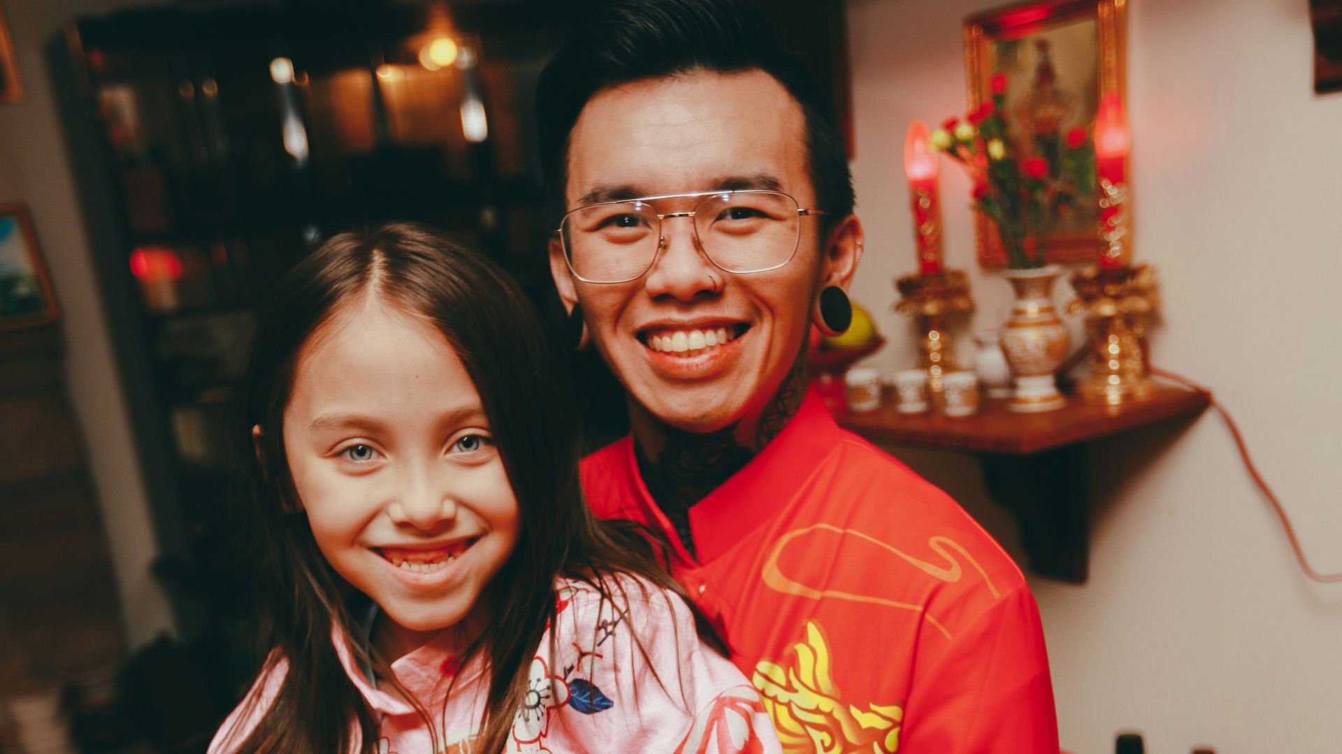 a man holding a girl in a room
