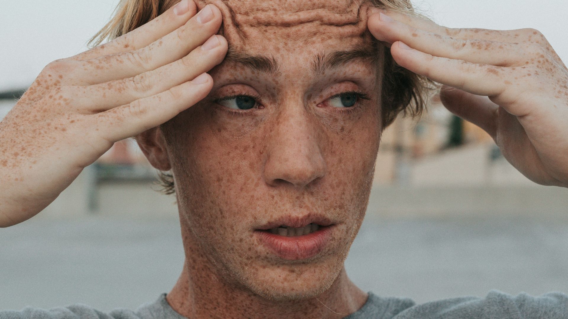 man in gray crew neck shirt with brown hair