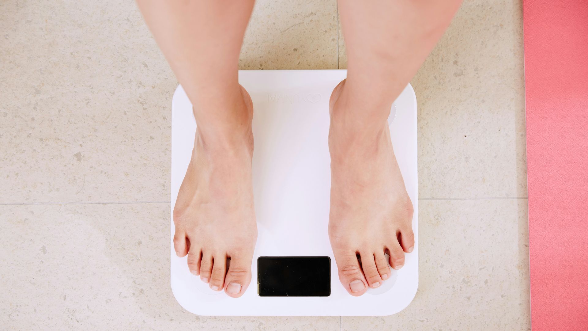 person standing on white digital bathroom scale