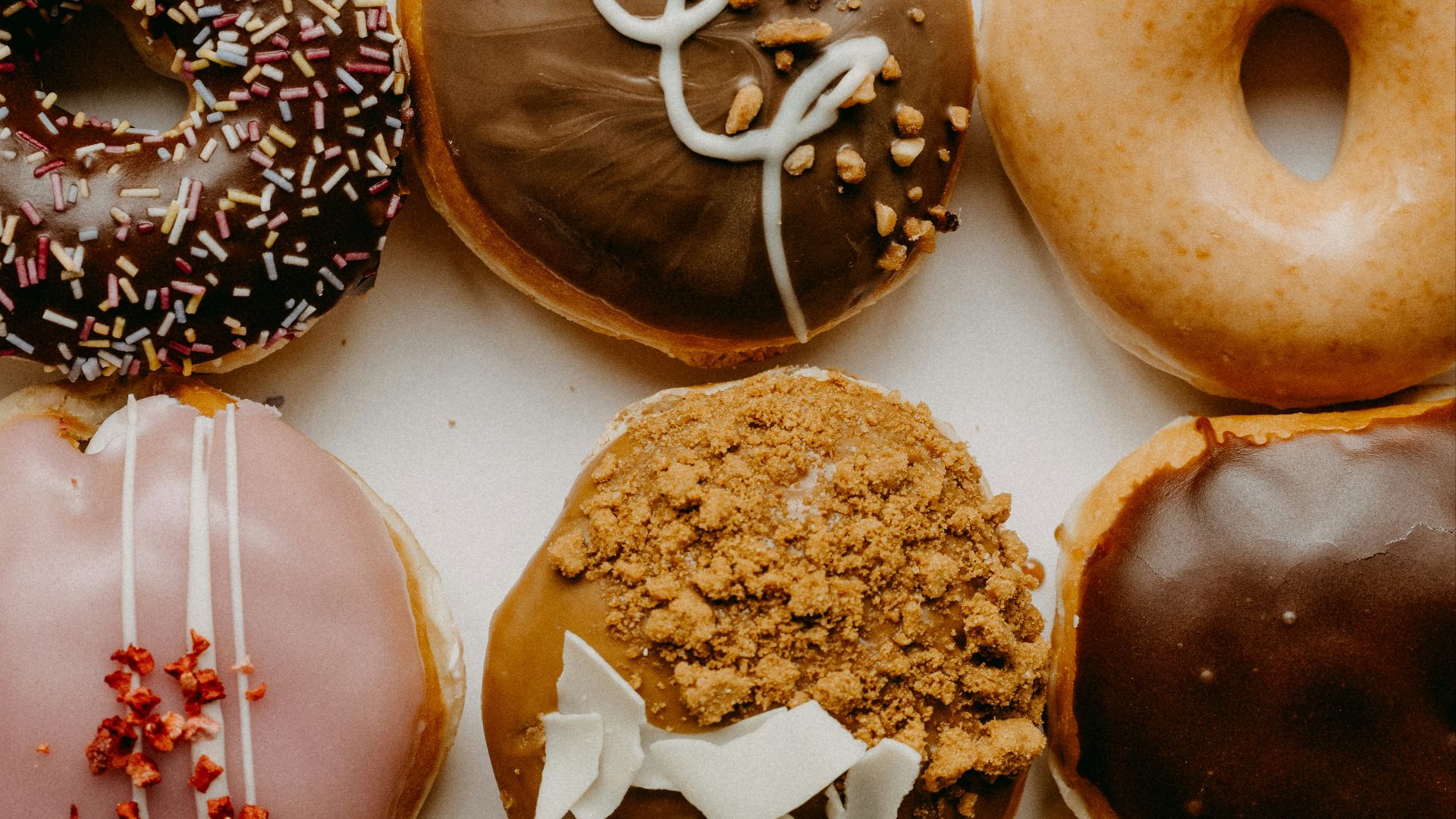 brown and white doughnuts on white ceramic plate