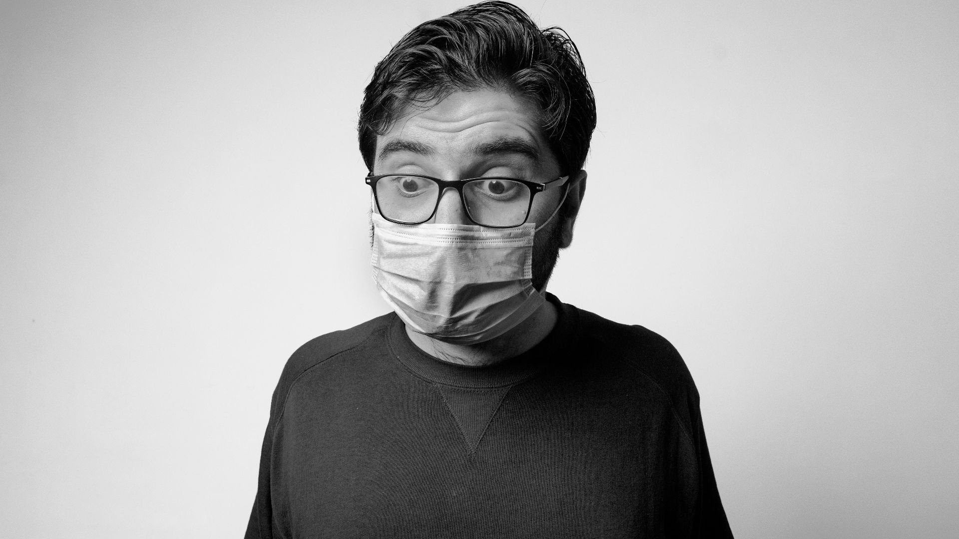 man in black turtleneck shirt wearing eyeglasses