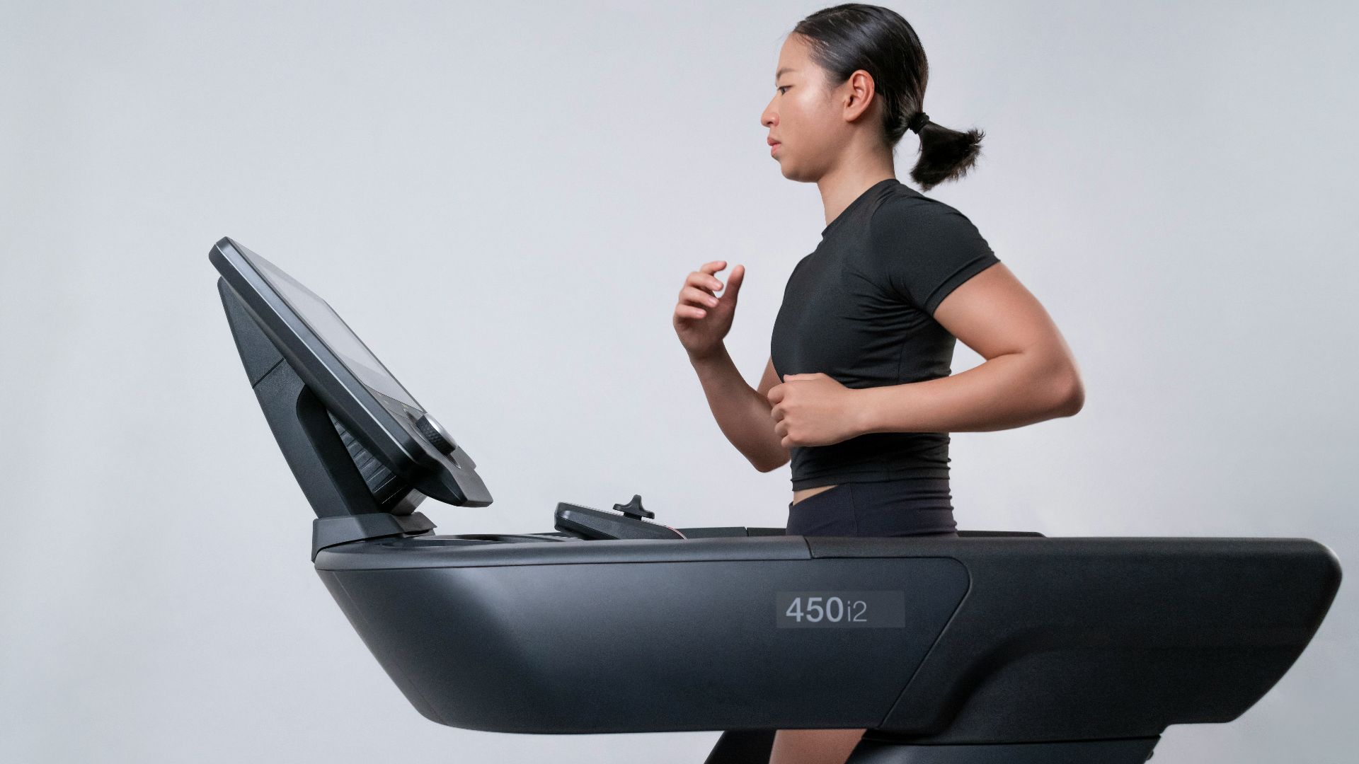 a woman is running on a treadmill