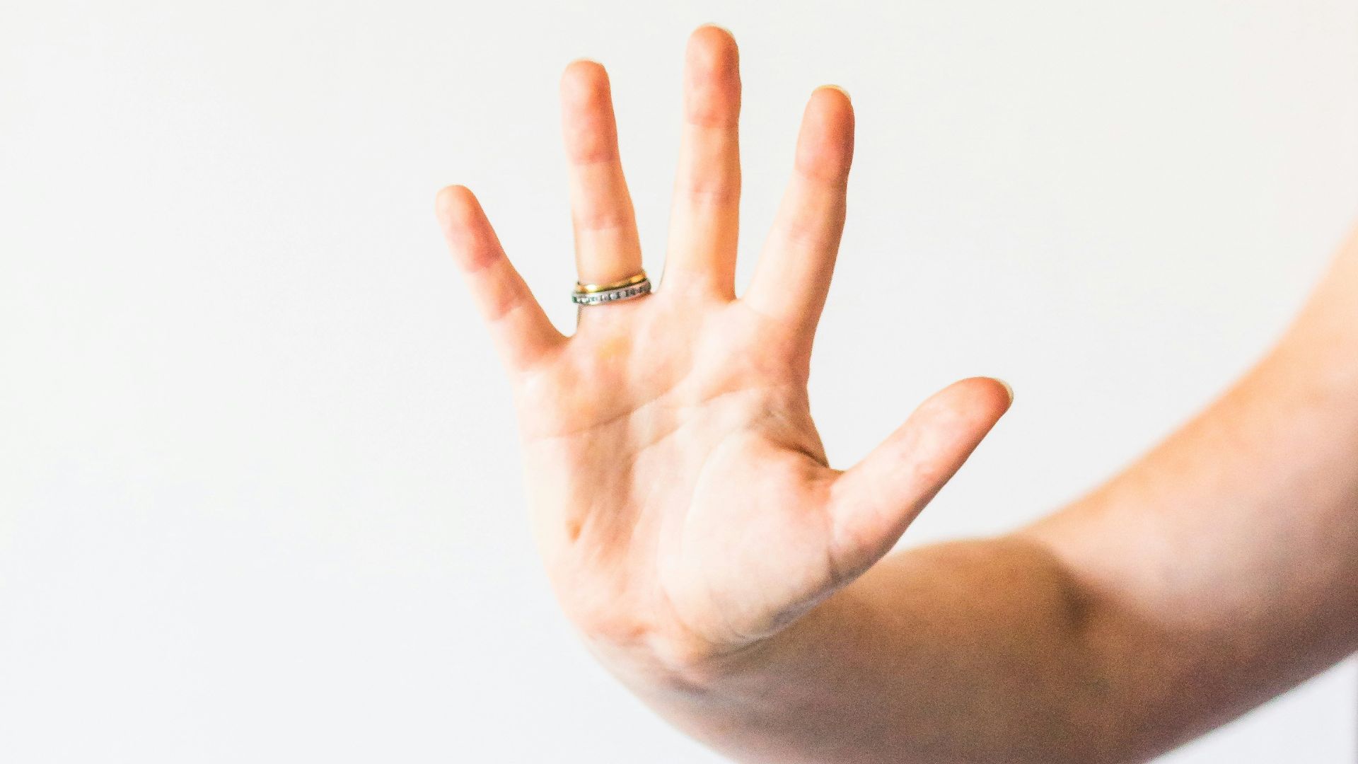 person wearing silver ring with diamond ring