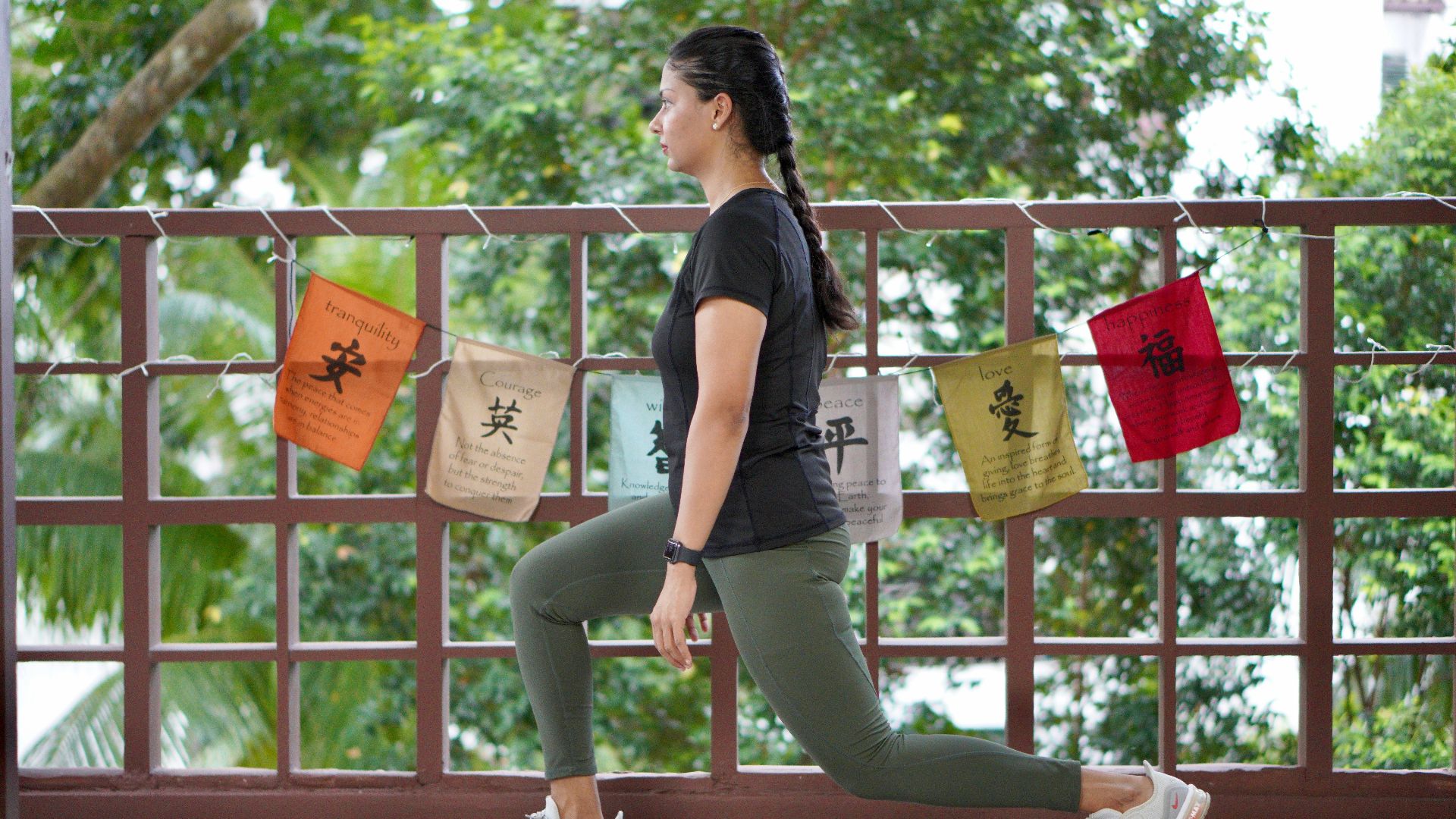 a woman in a black shirt is doing yoga