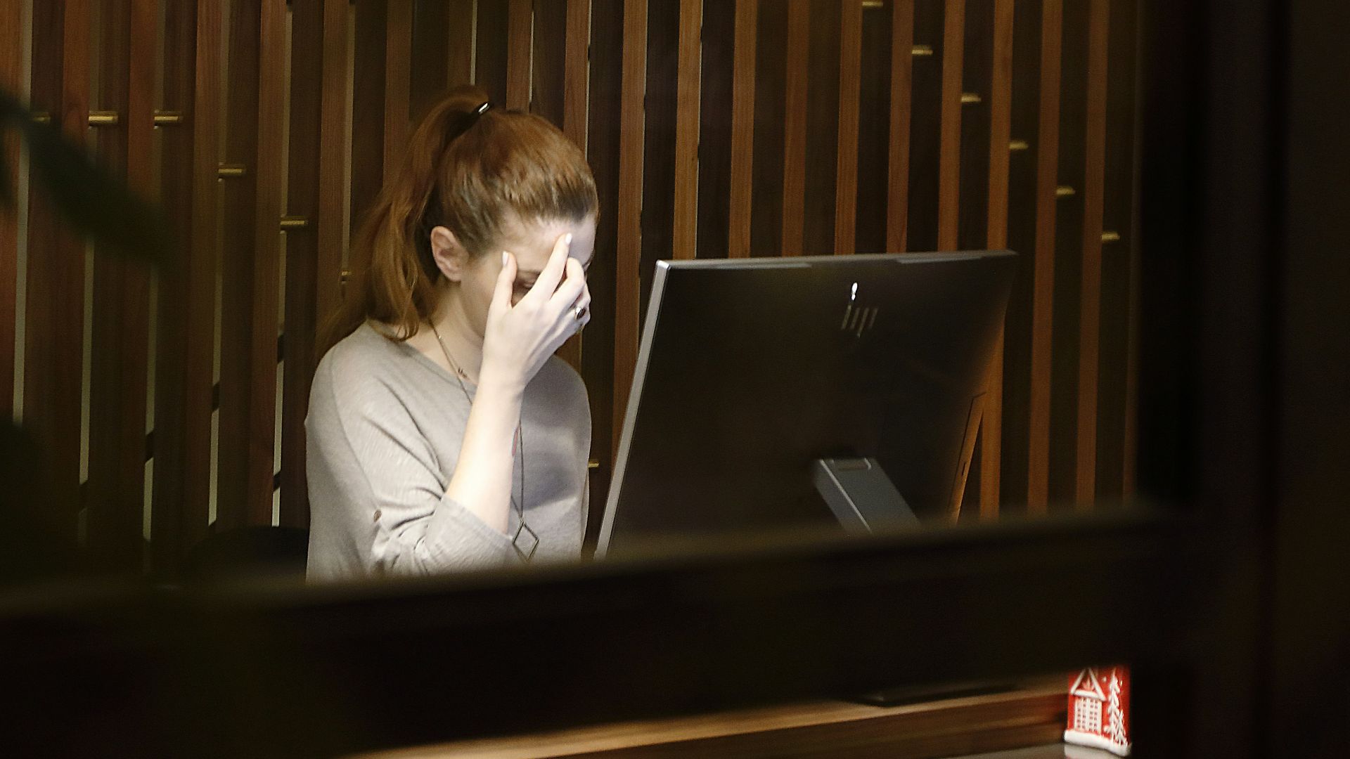 a woman sitting in front of a laptop computer