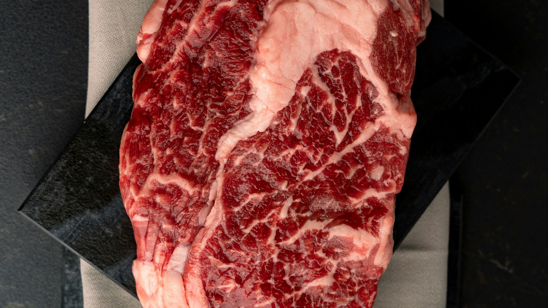 A piece of meat sitting on top of a piece of paper