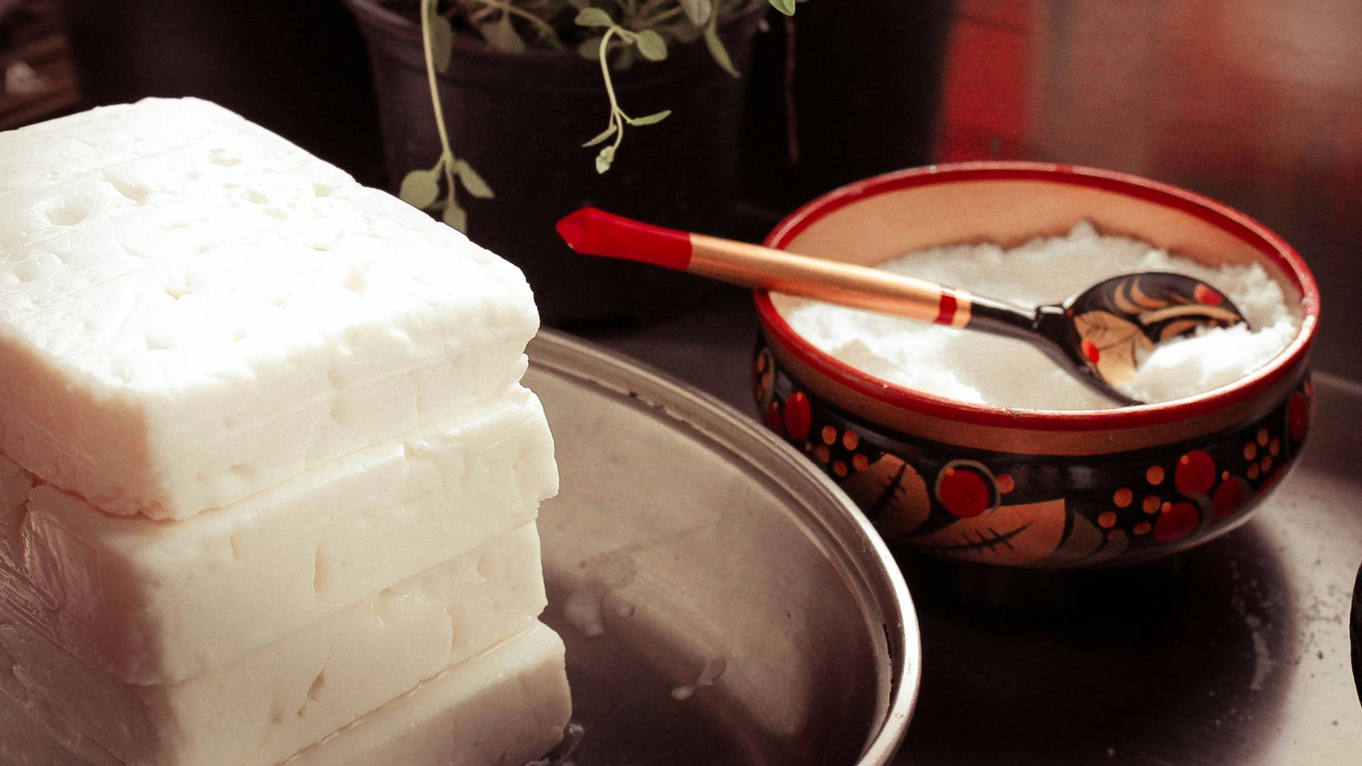 red ceramic bowl on gray spoon