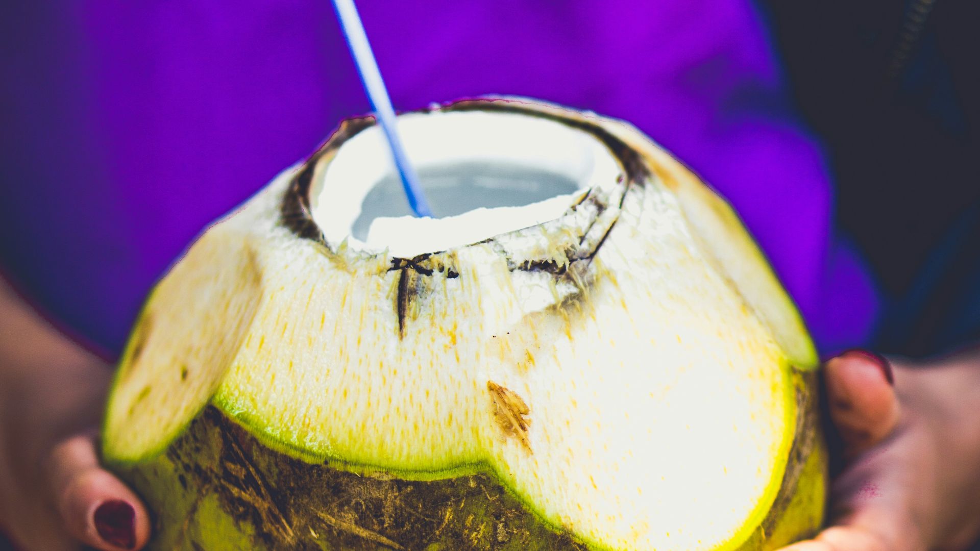person holding coconut juice