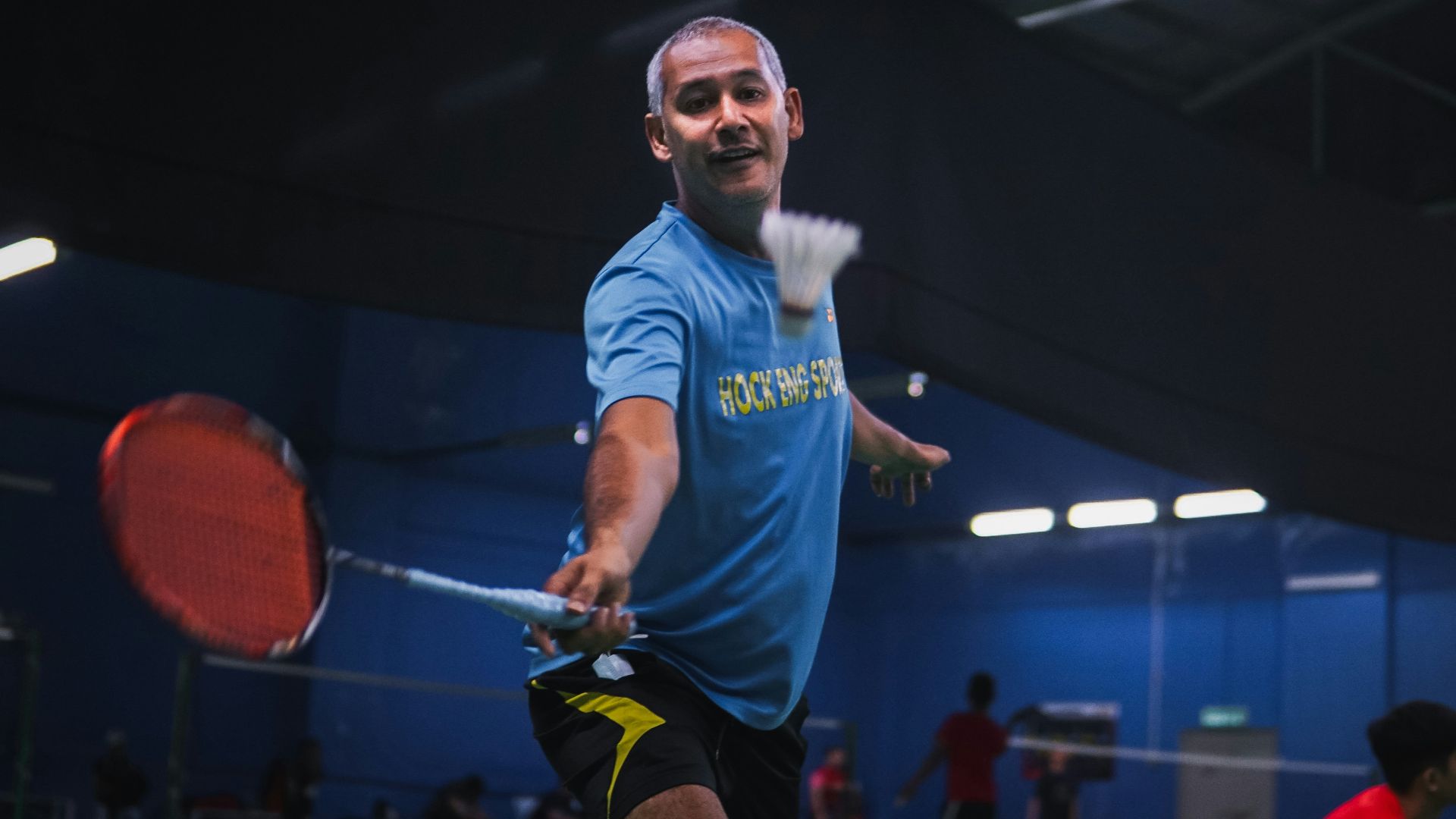 man in blue crew neck t-shirt and black shorts holding red basketball