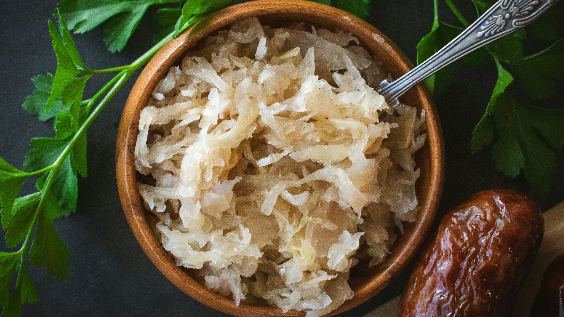 a wooden bowl filled with rice next to a spoon