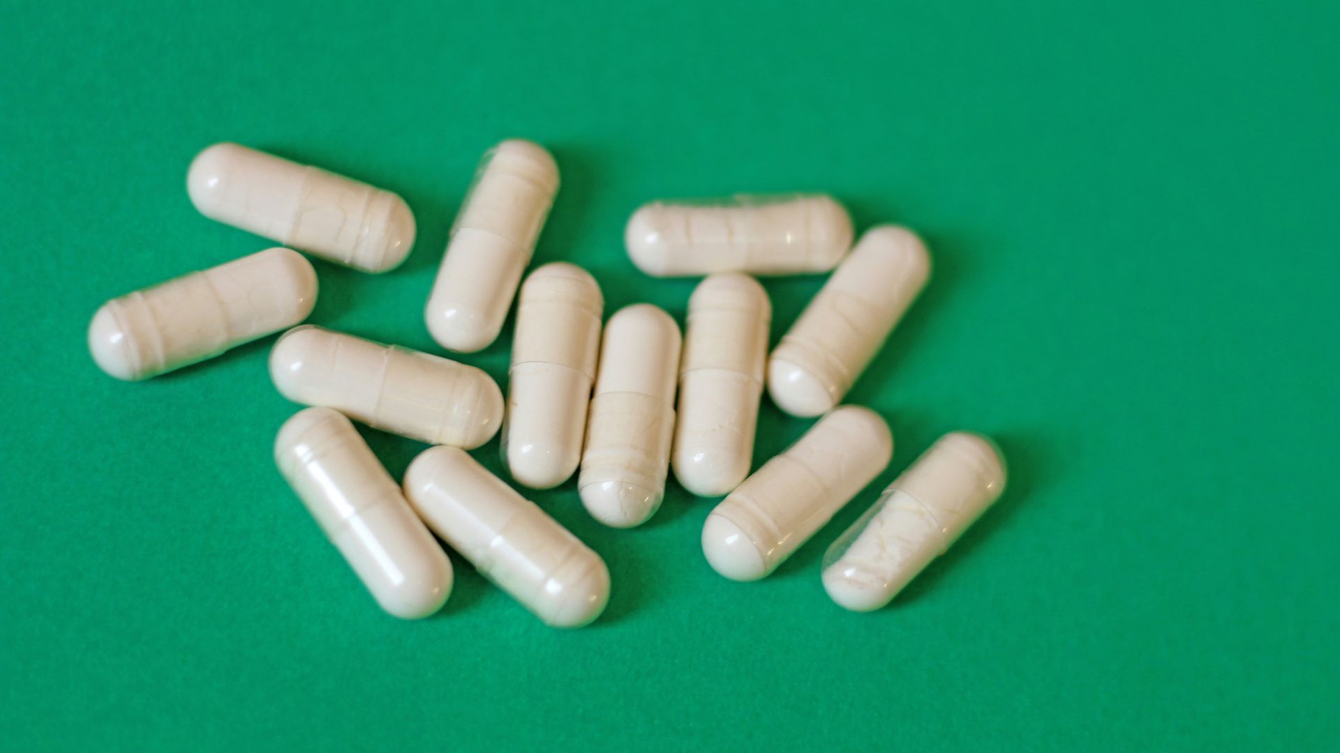 A pile of pills sitting on top of a green table