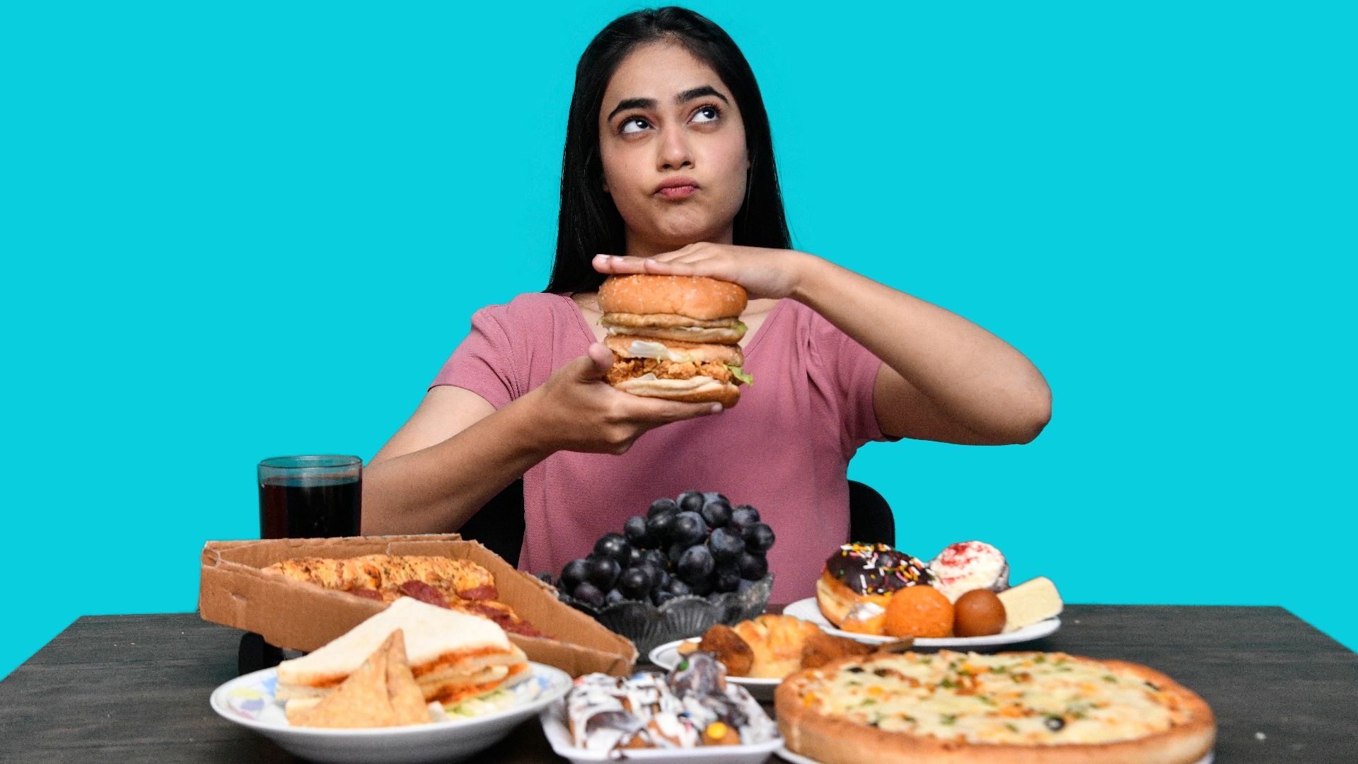 a woman holding a burger