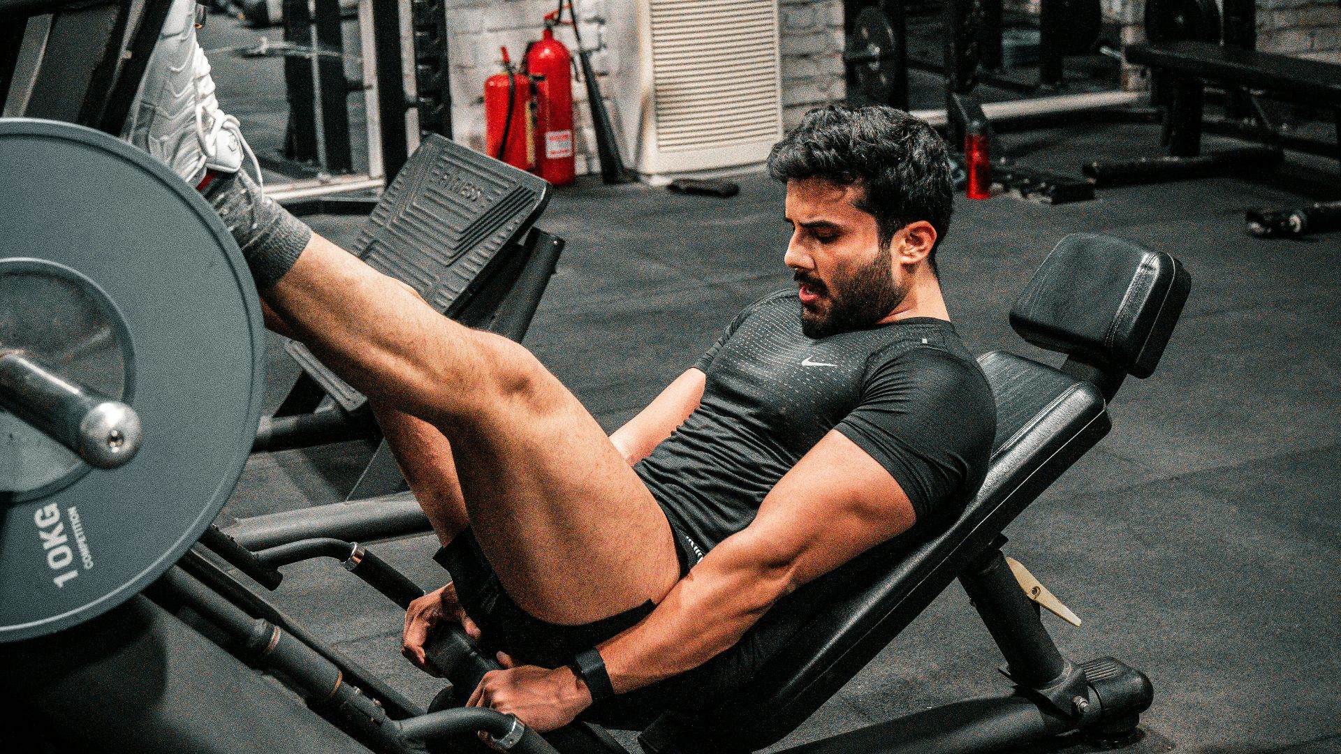 Man is working out on a leg press machine.