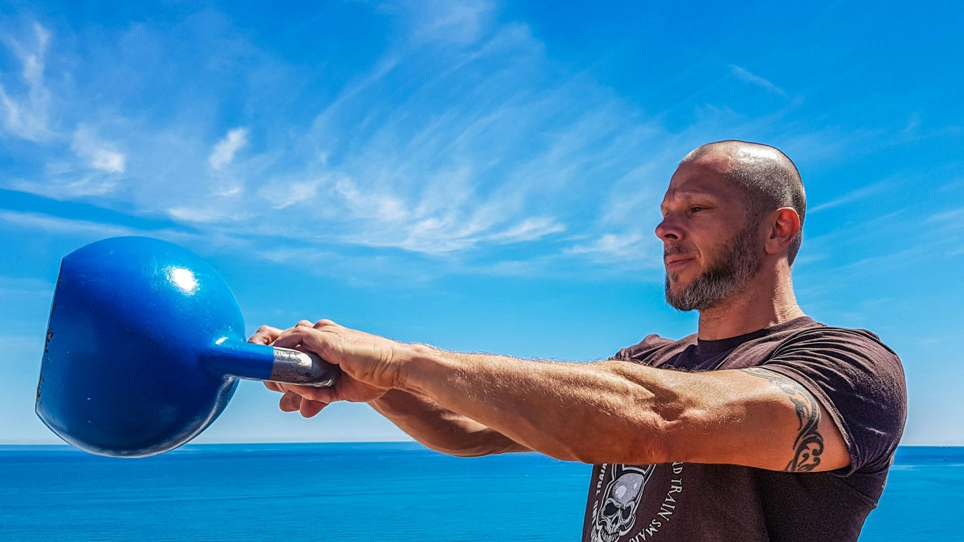 man carrying blue kettle