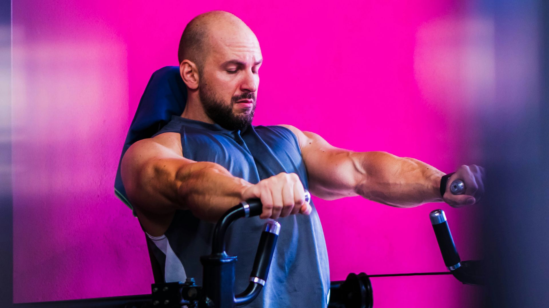 a man sitting on top of a bench holding a bar