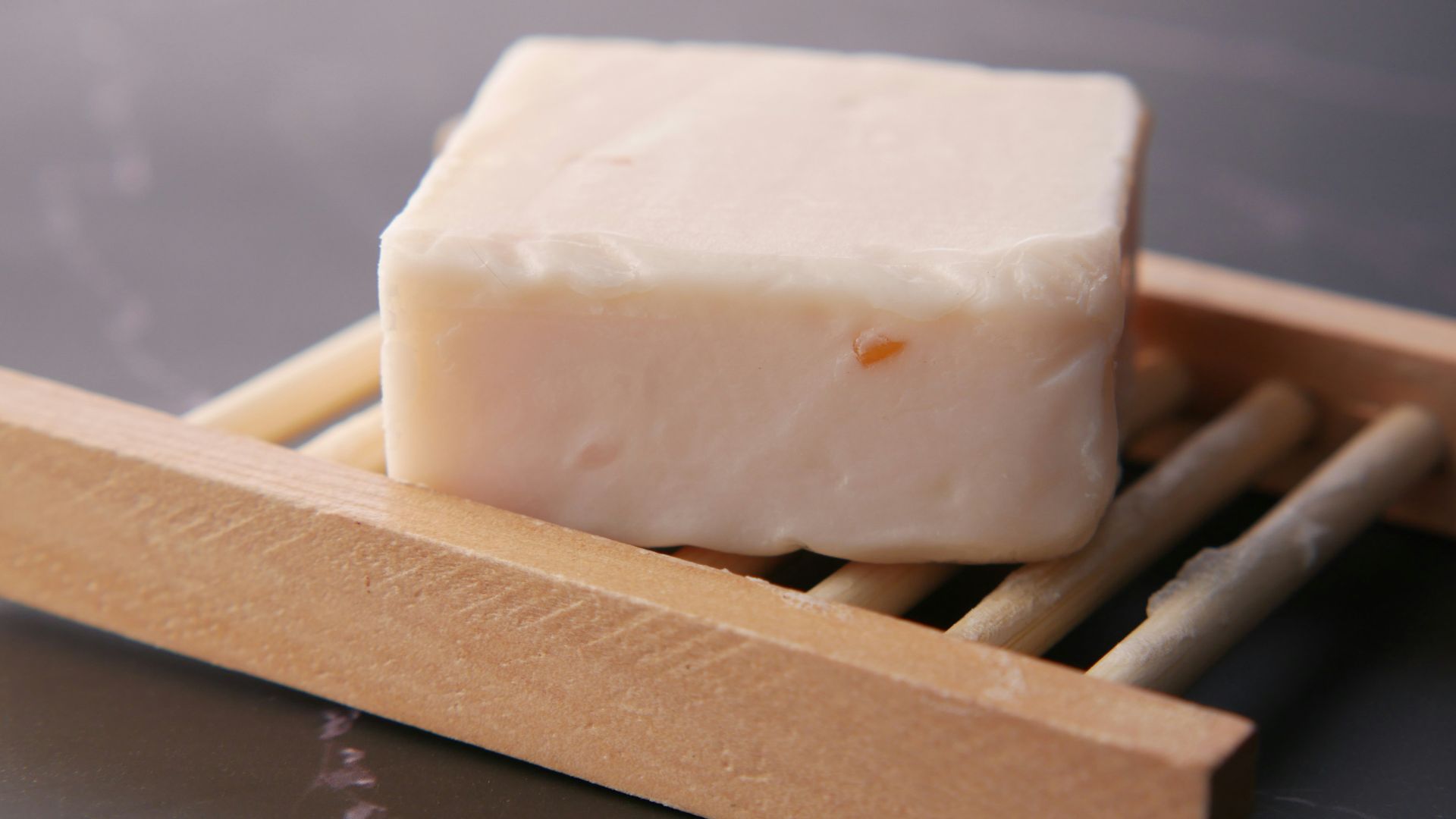 a block of soap sitting on top of chopsticks