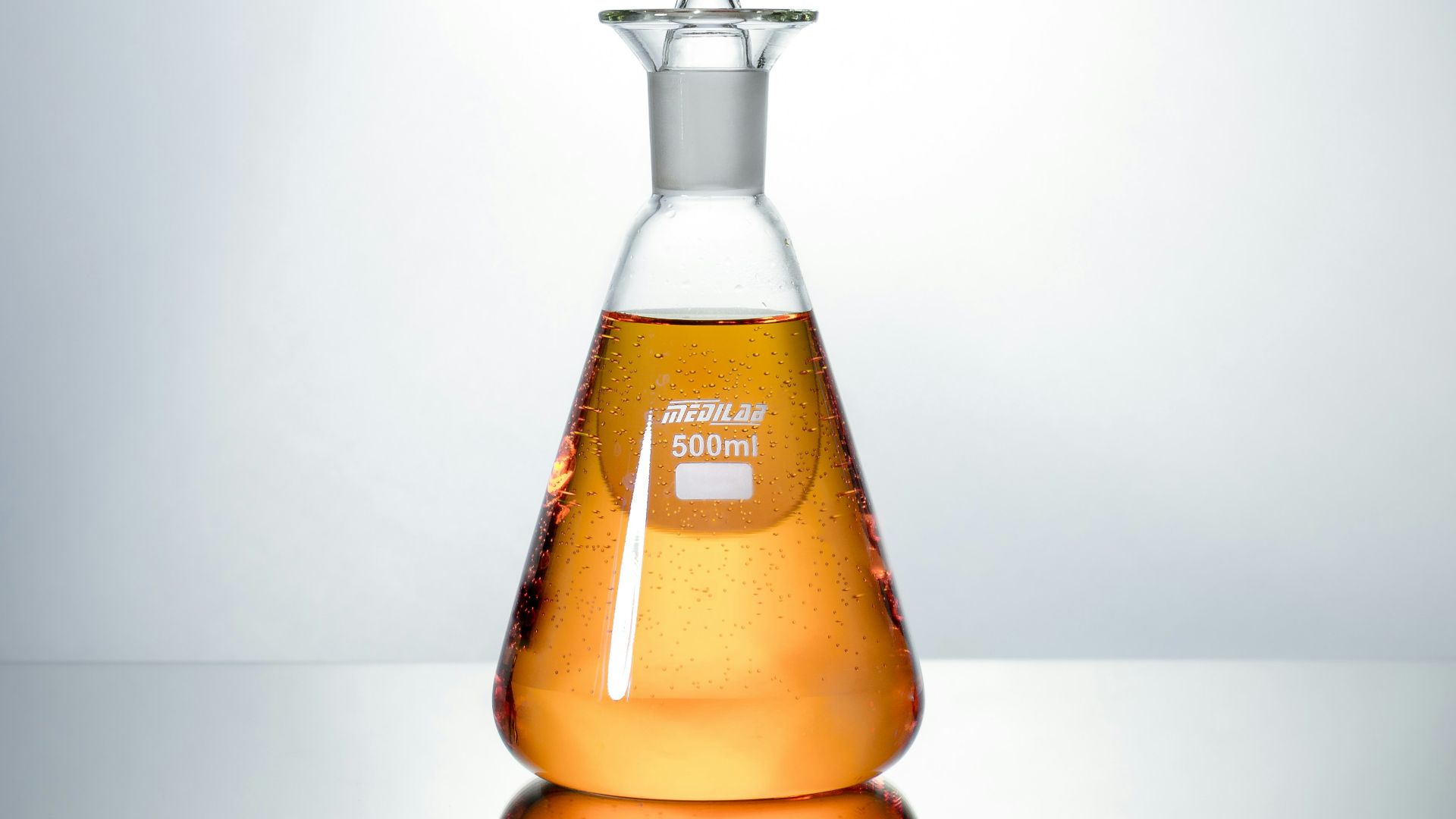 clear glass bottle with brown liquid