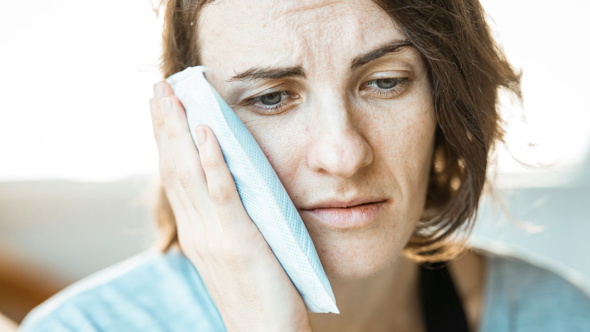 woman in black tank top holding white textile