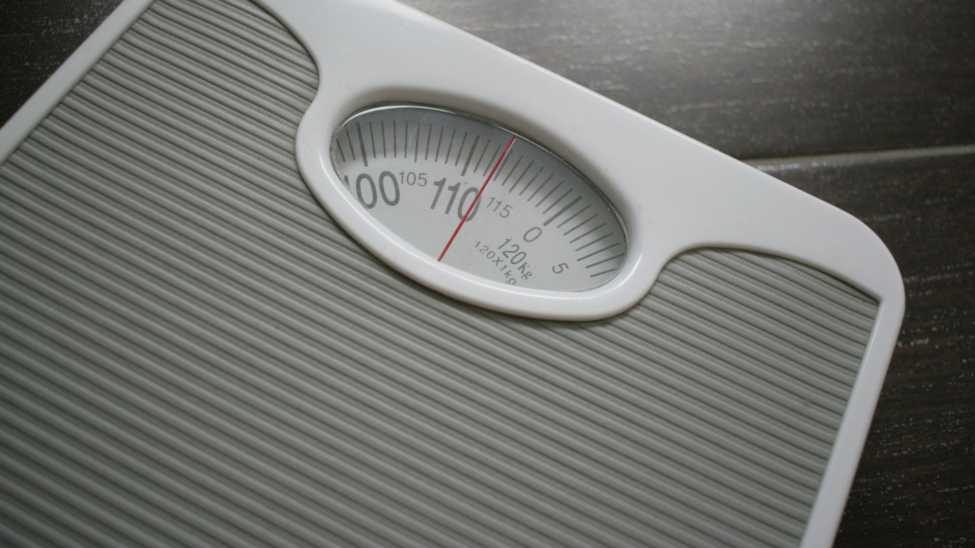 a bathroom scale sitting on top of a wooden table