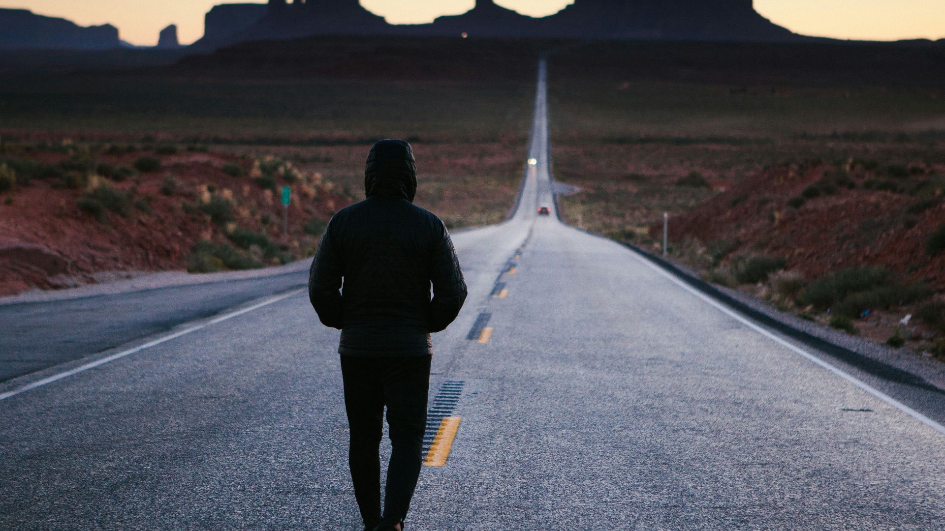 person walking in the center of the road
