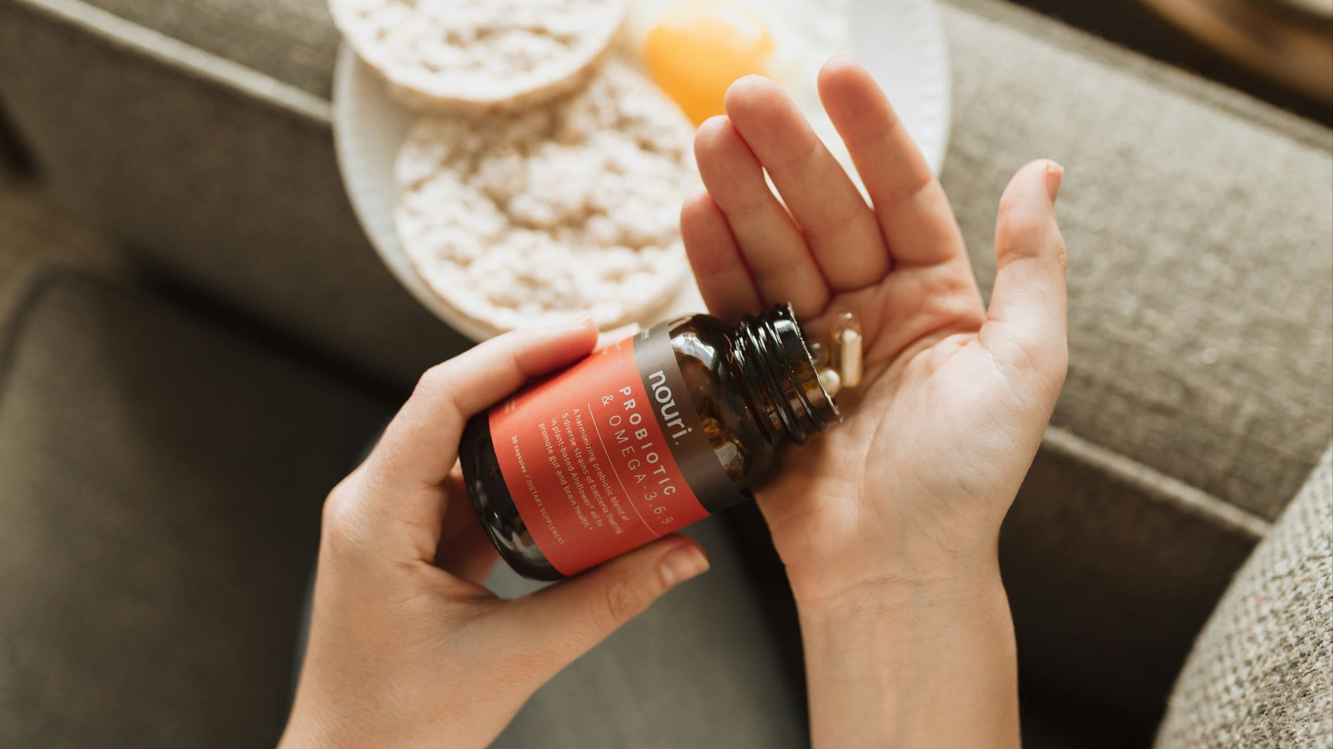 person holding red bottle