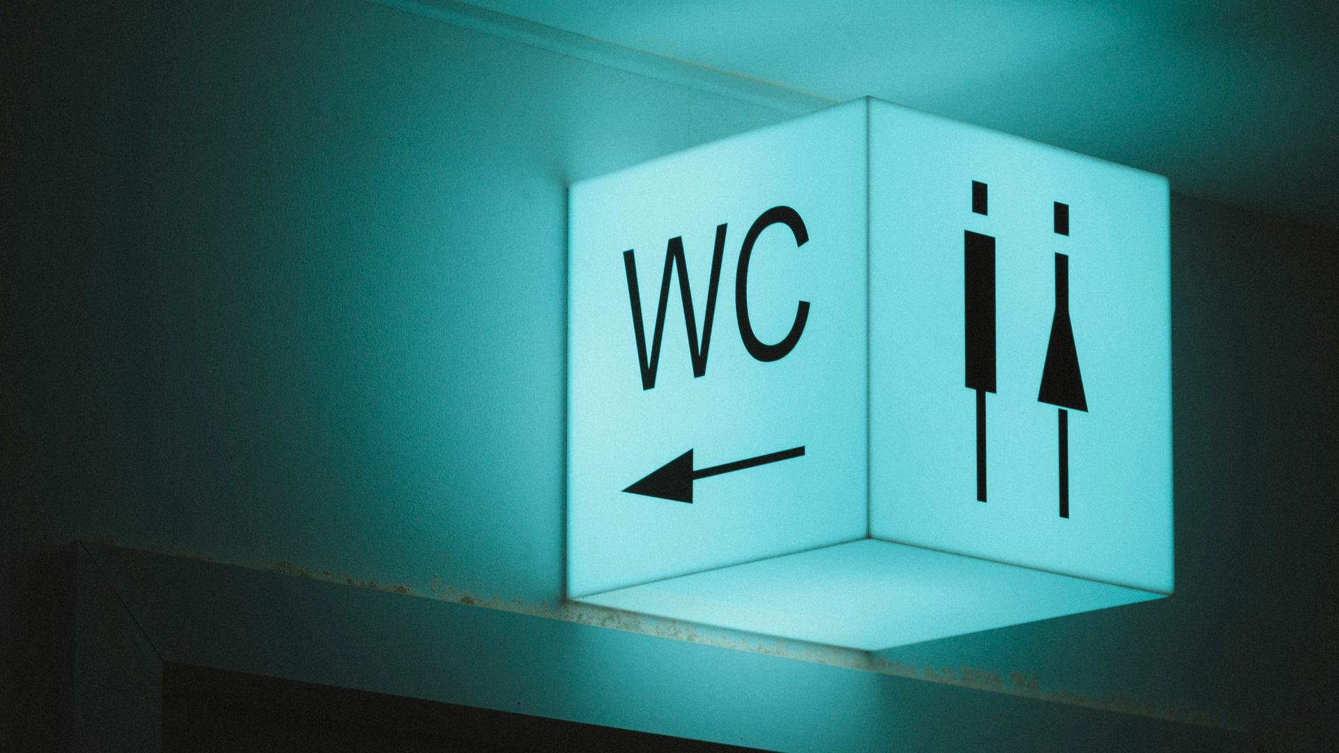white and blue wall mounted exit sign