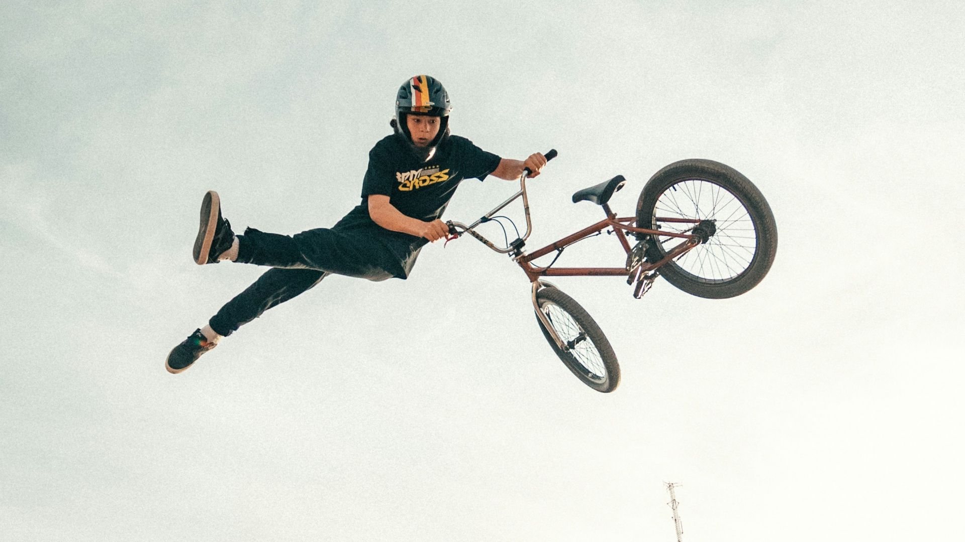 man in red shirt riding on bicycle on brown rock mountain during daytime