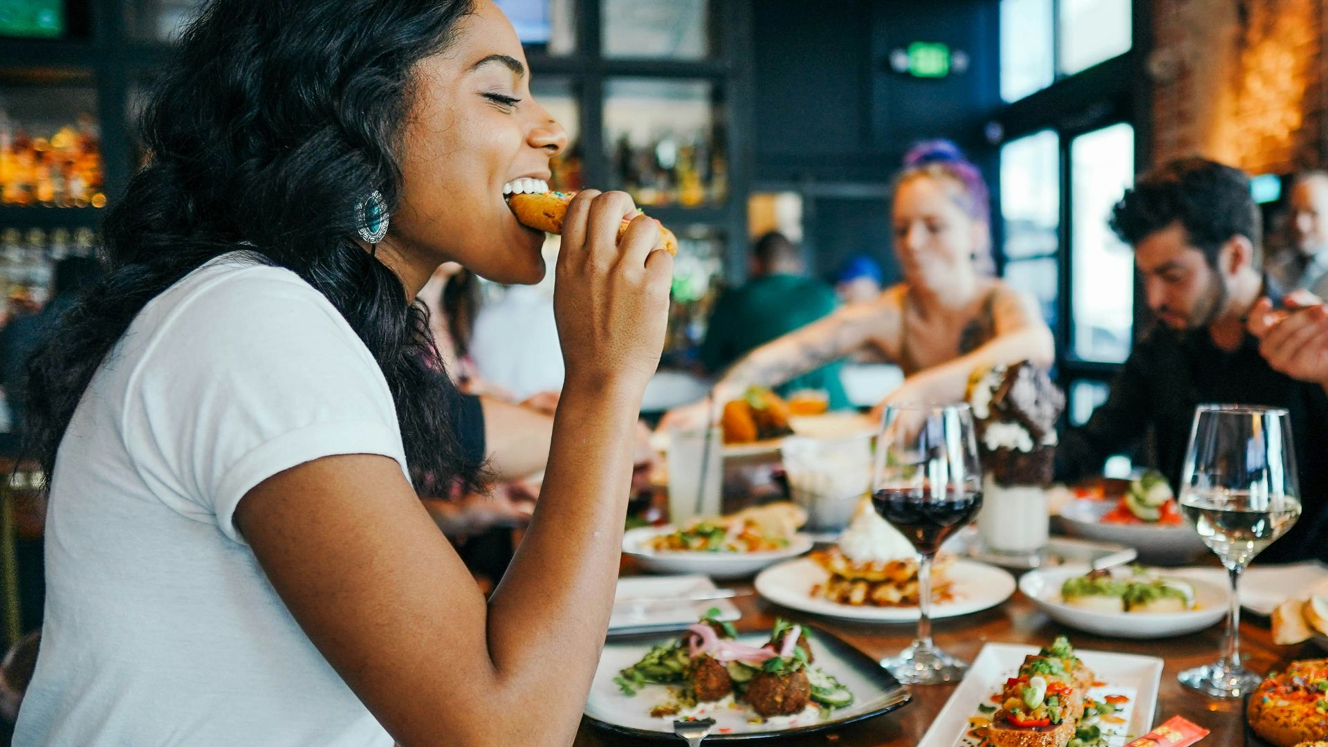 woman in white shirt eating