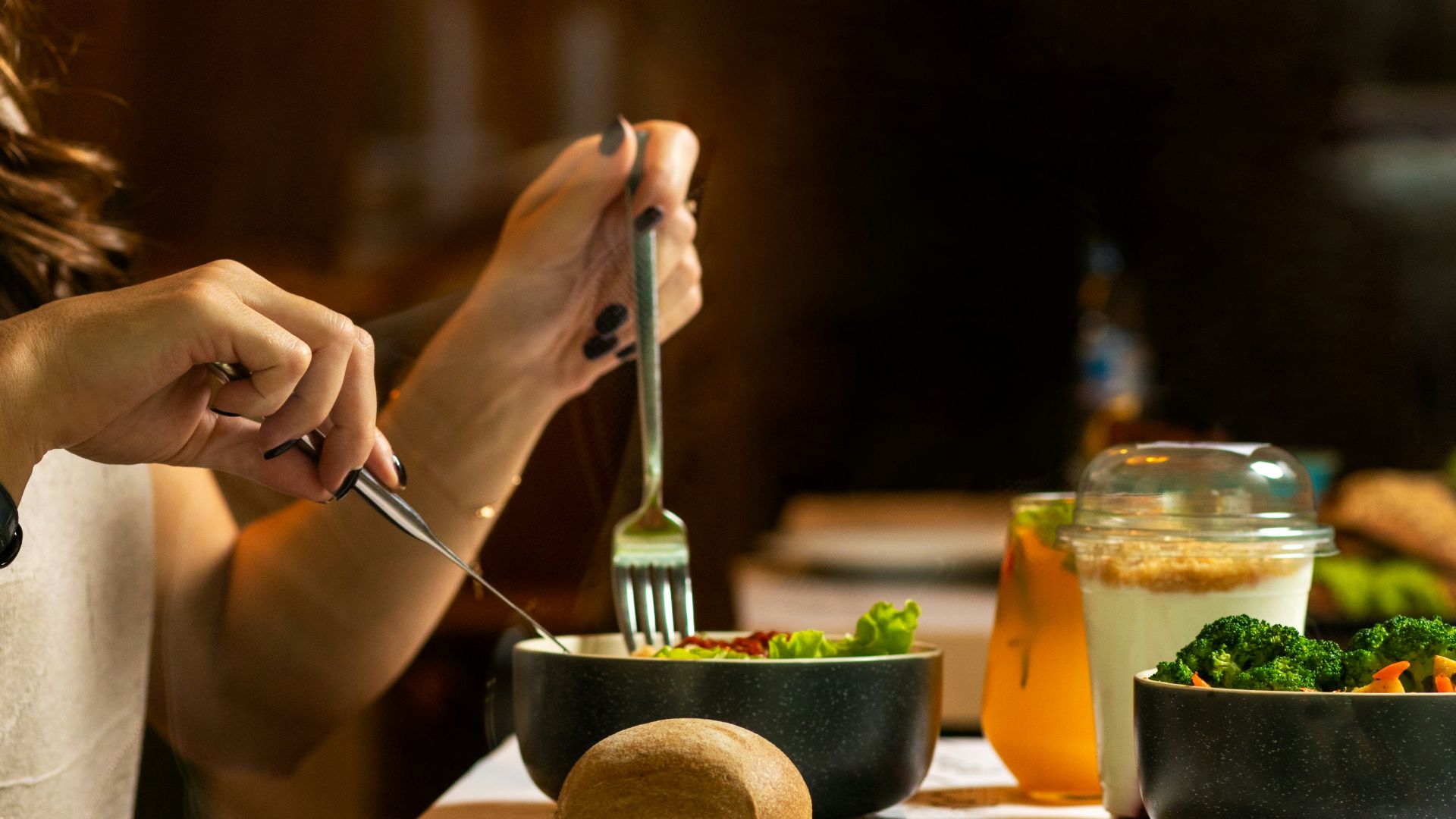 person holding silver fork and knife