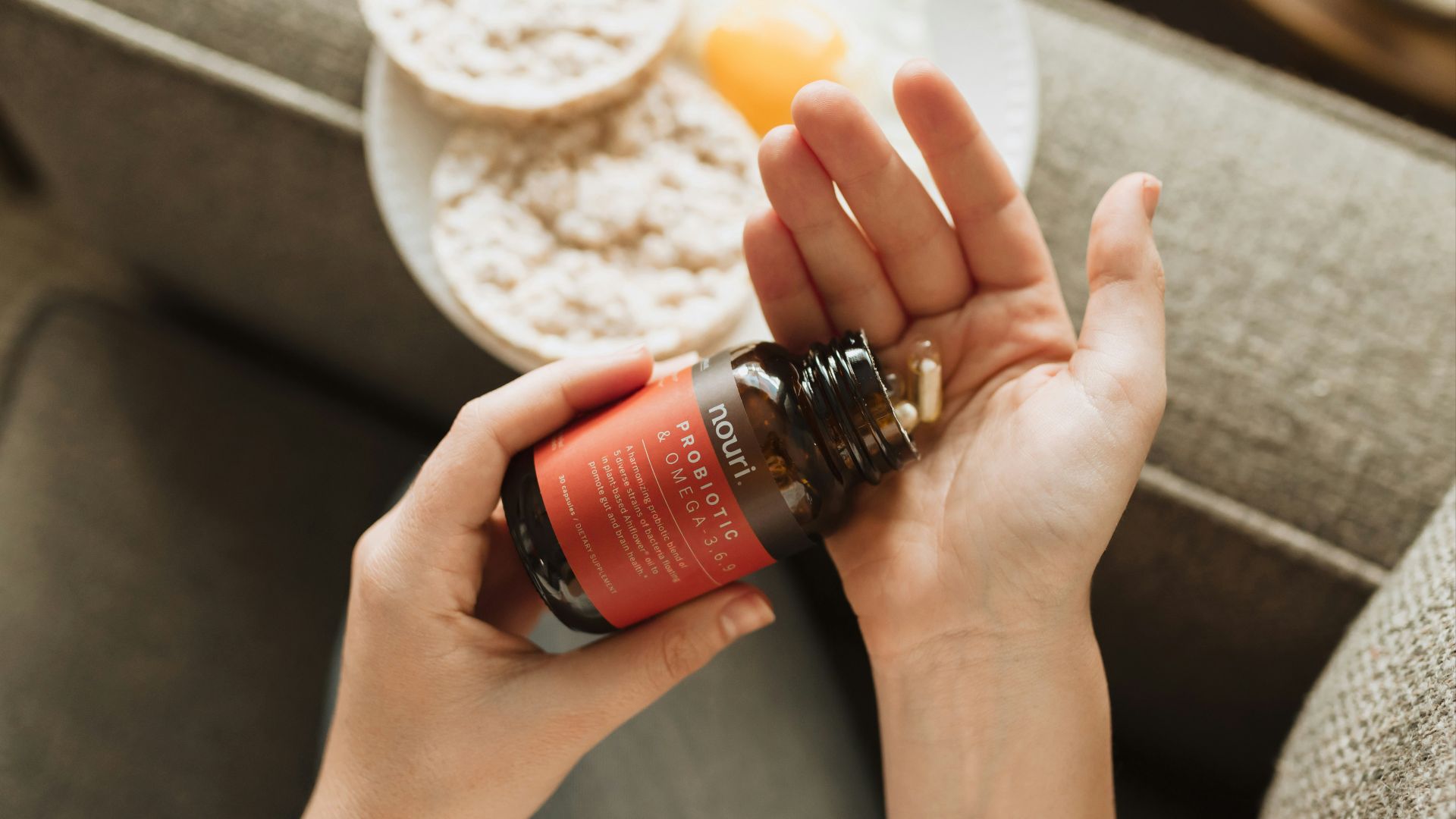 person holding red bottle