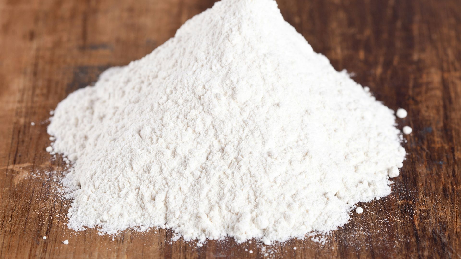 A pile of white powder sitting on top of a wooden table