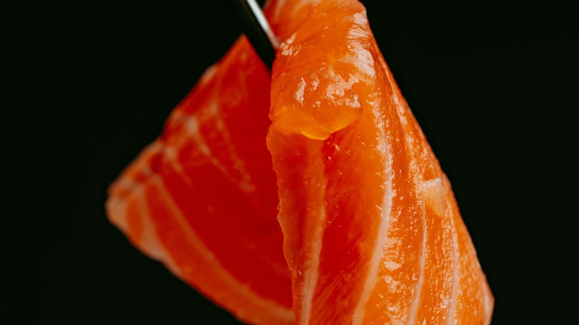 a piece of sushi with chopsticks sticking out of it