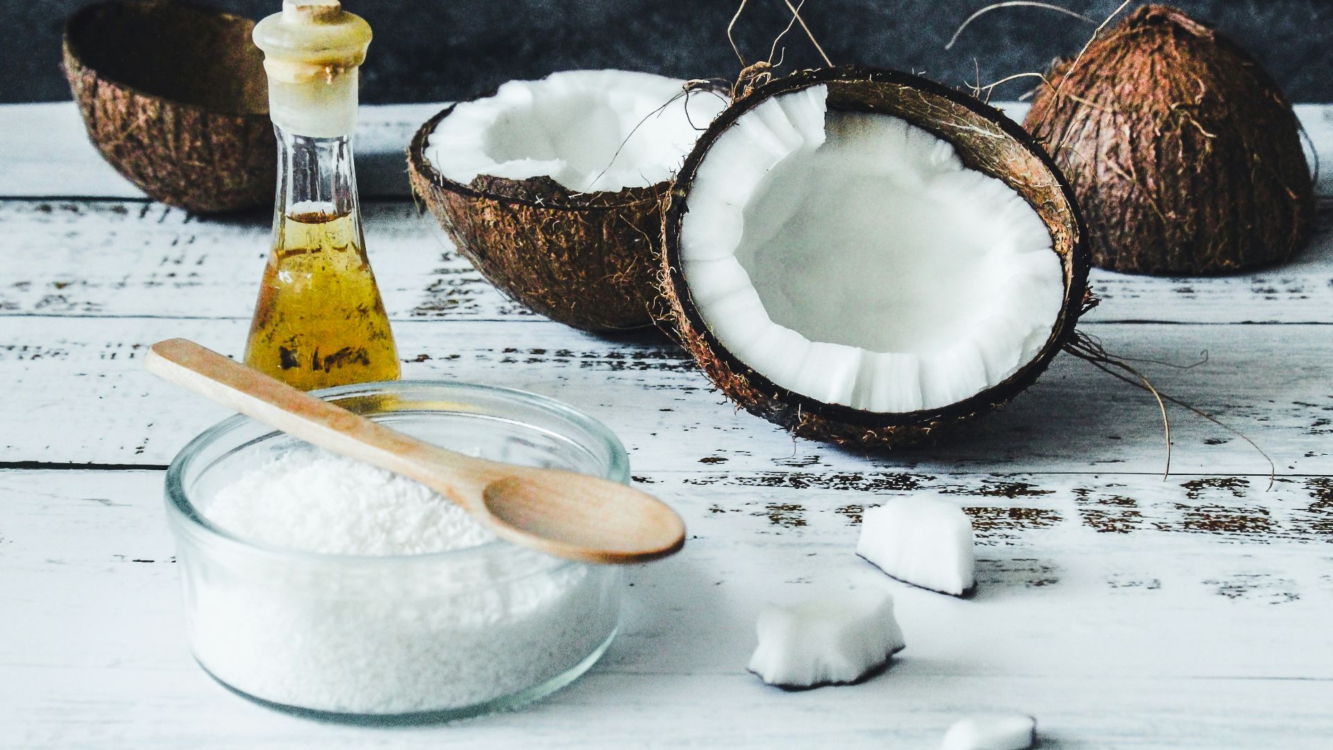 white powder in clear glass jar beside brown wooden spoon