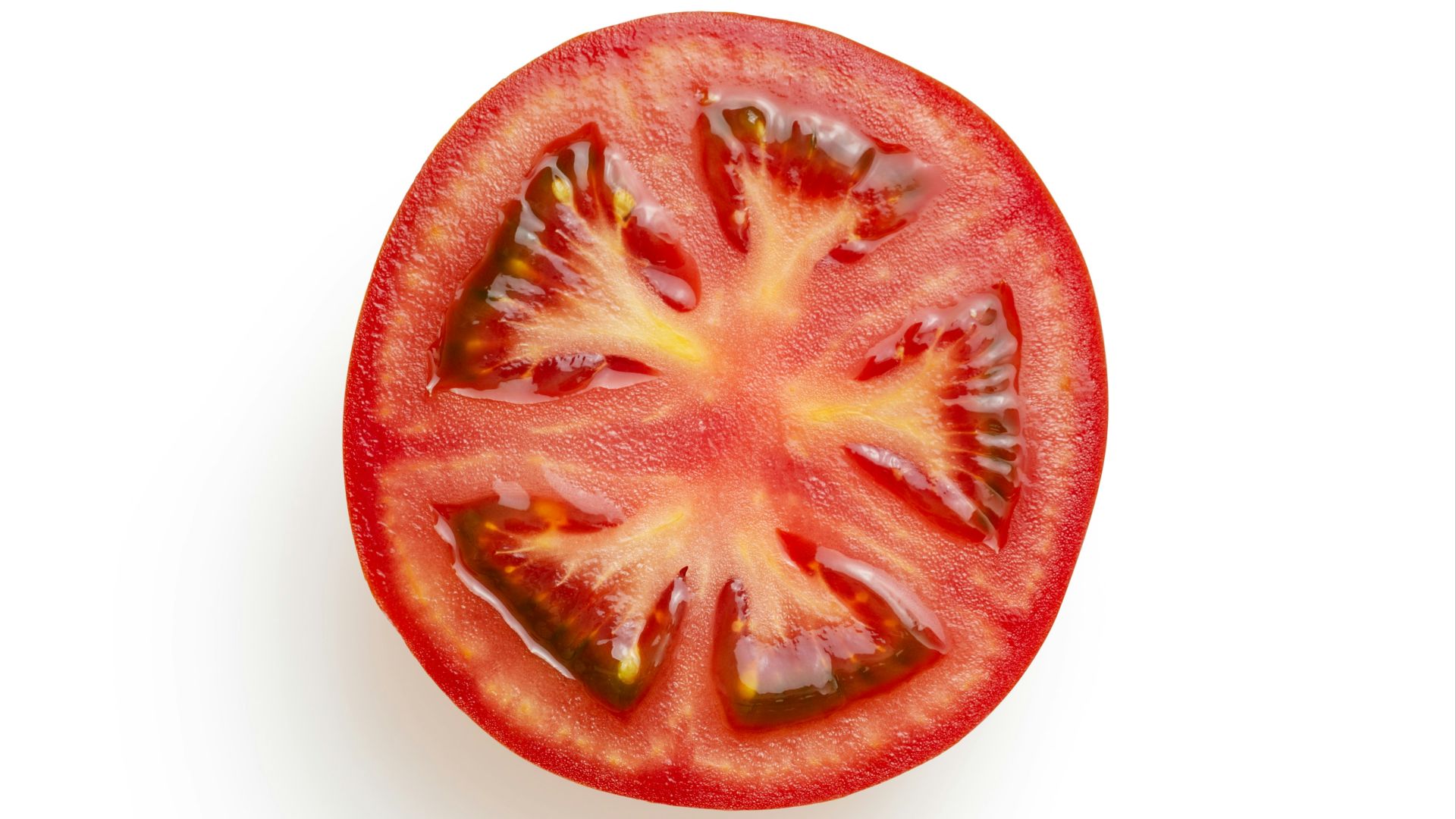 sliced tomato on white surface