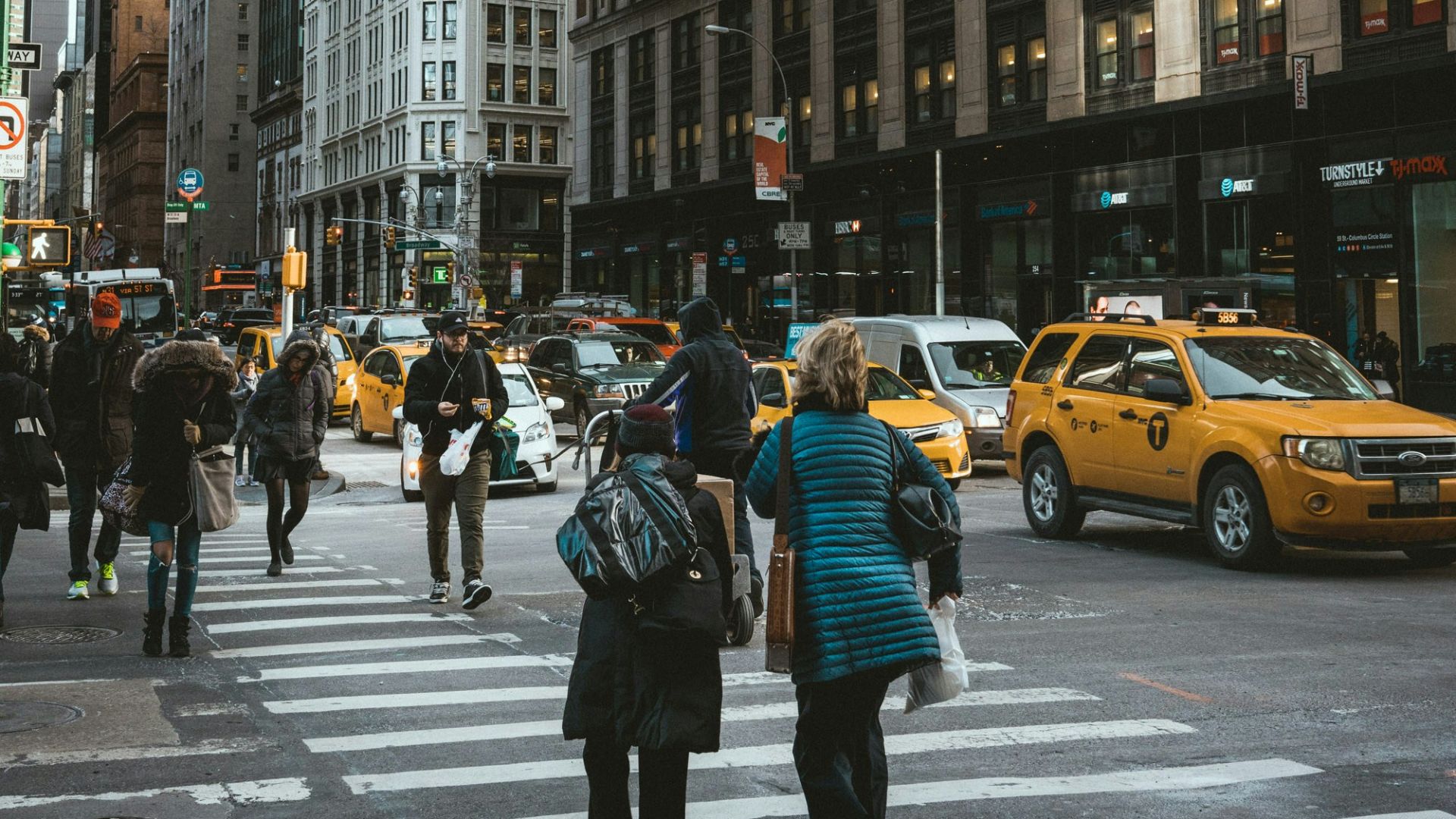 group of people crossing pedestrian lane