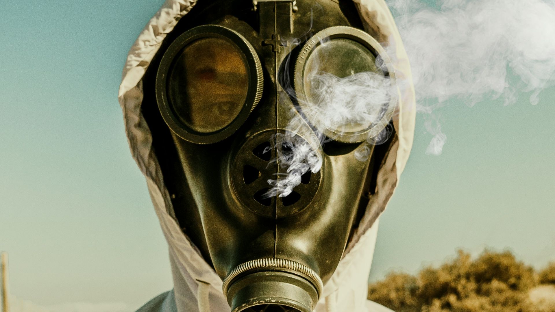 person wearing white and blue gas mask