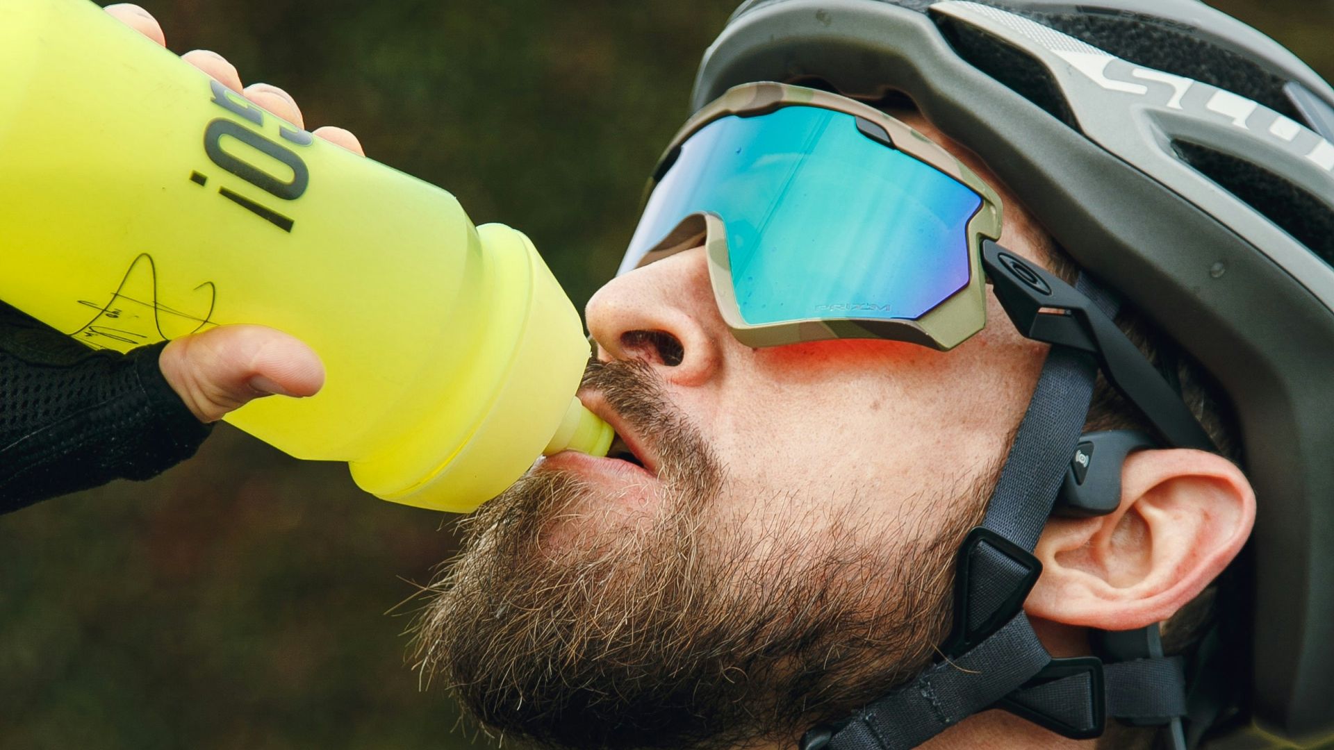 man in purple crew neck shirt wearing black and green goggles