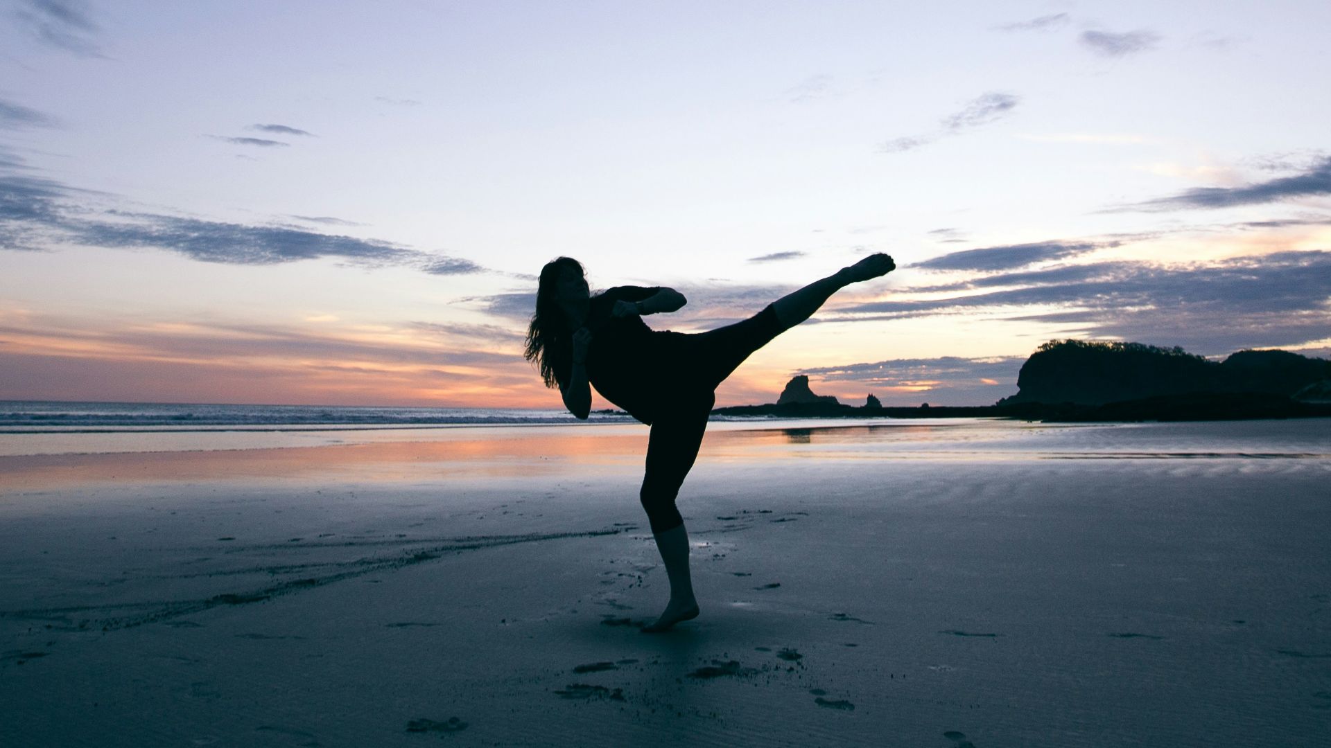 silhouette of person kicking on mid air