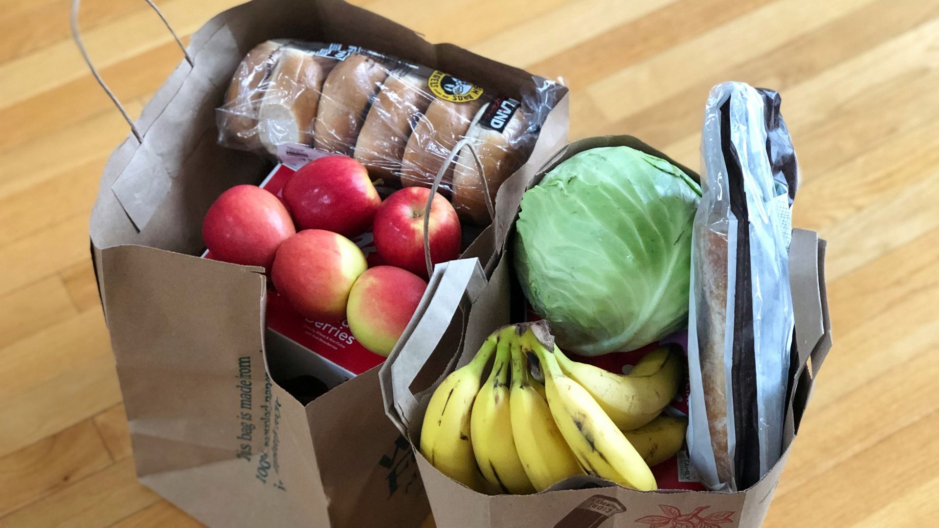 apples and bananas in brown cardboard box