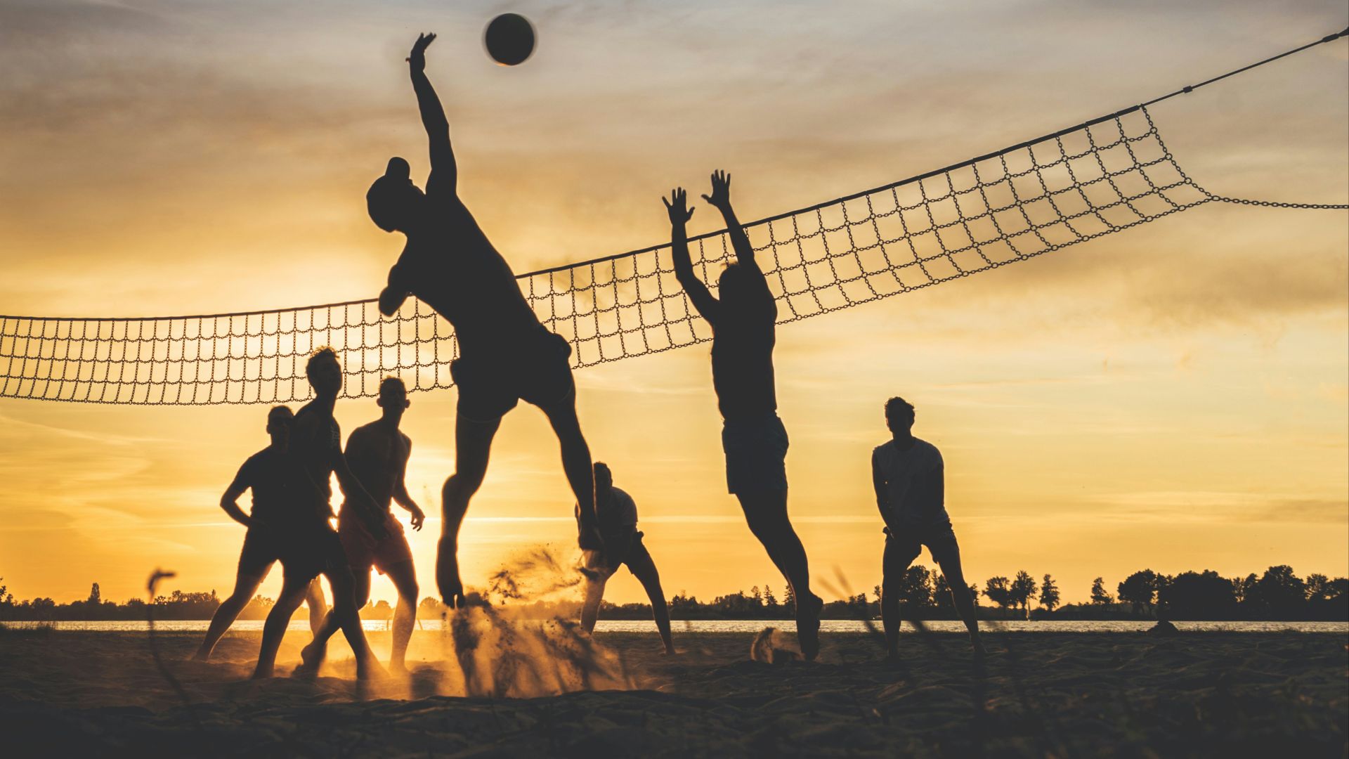 silhouette of people playing basketball during sunset