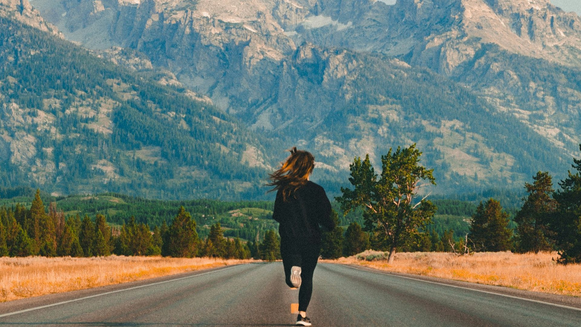 woman walking on road during daytime